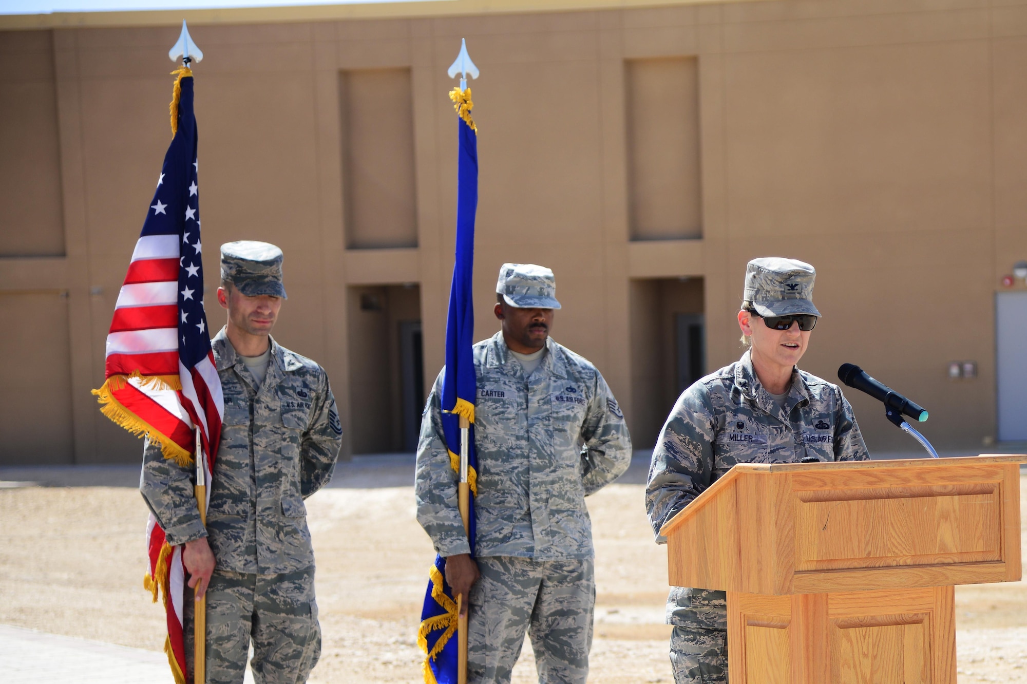 U.S. Air Force Col. Caroline Miller, 379th Expeditionary Mission Support Group commander, gives remarks during a linen cutting ceremony, April 3, 2015, at Al Udeid Air Base, Qatar. The linen cutting ceremony symbolized the opening of the new Phase II dormitories in the Blatchford-Preston Complex. (U.S. Air Force photo by Senior Airman Kia Atkins)