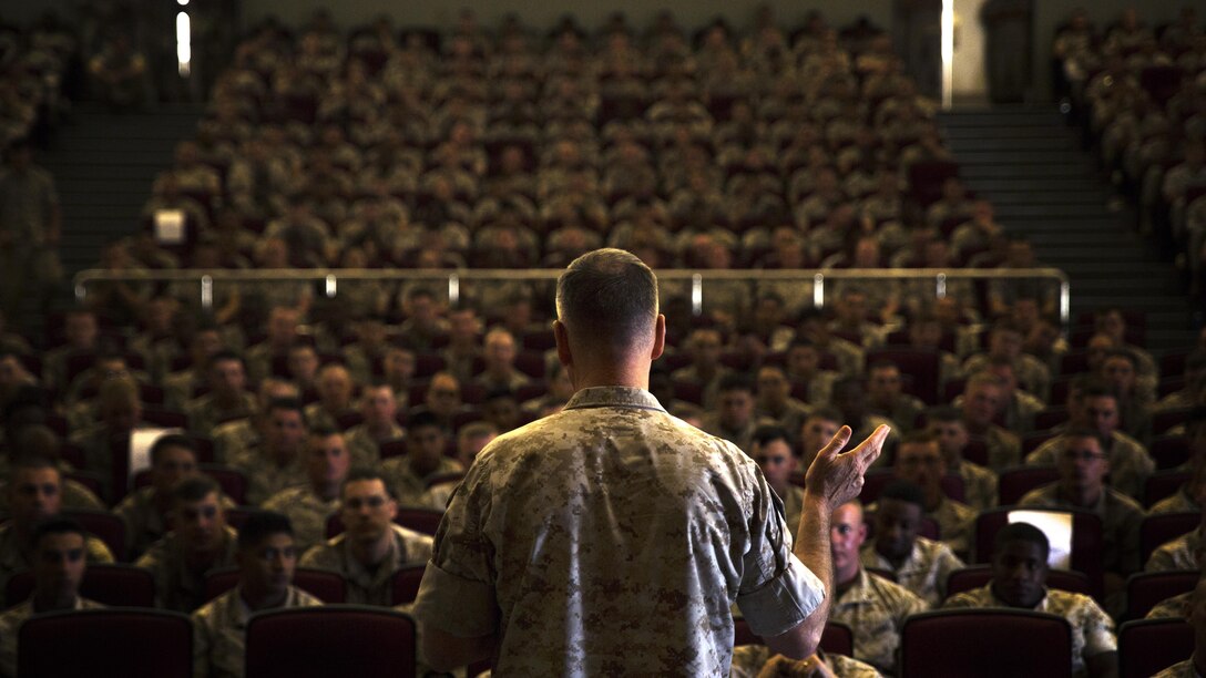 Commandant of the Marine Corps Gen. Joseph F.  Dunford, Jr., speaks to Okinawa-based personnel at a town hall meeting March 25 in the Camp Foster Theater, Okinawa, Japan. Dunford and Sgt. Maj. of the Marine Corps Ronald L. Green spoke about Dunford’s planning guidance and the future of the Corps at various installations across Okinawa. The CMC also answered questions on topics such as women in the infantry and international crisis response. Other questions dealt with the growing field of cyber warfare and the Corps’ tattoo policy. 