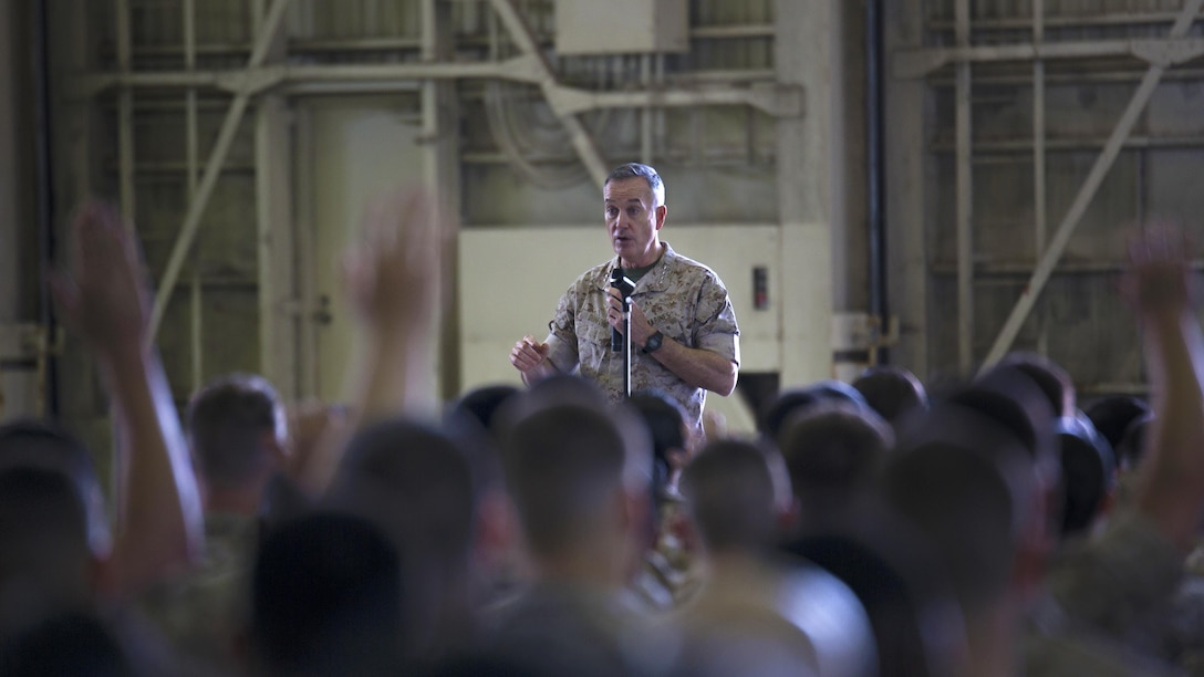 Commandant of the Marine Corps Gen. Joseph F.  Dunford, Jr., speaks to Okinawa-based personnel at a town hall meeting in Marine Medium Tiltrotor Squadron 262’s Hangar 525 March 26 on Marine Corps Air Station Futenma, Okinawa, Japan. Dunford and Sgt. Maj. of the Marine Corps Ronald L. Green spoke about about Dunford’s planning guidance and the future of the Corps at various installations across Okinawa. Dunford also answered questions on topics such as women in the infantry and international crisis response. Other queries dealt with the growing field of cyber warfare and the Corps’ tattoo policy. 