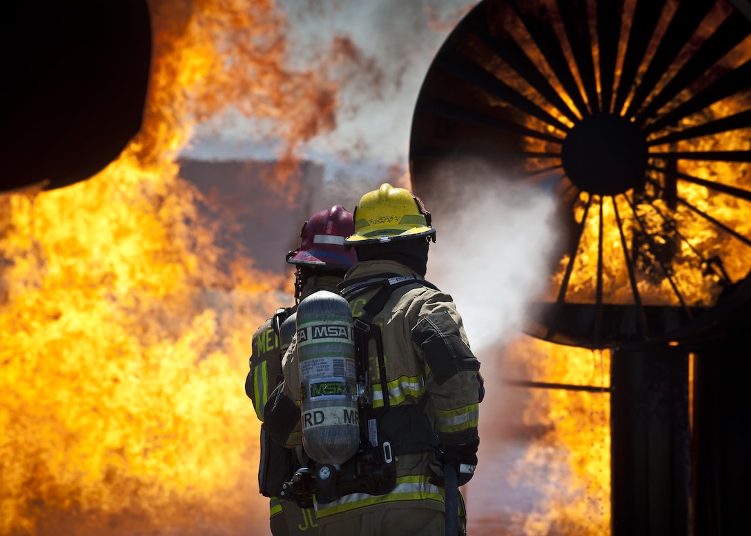 Firefighters extinguish an aircraft fire during training at the burn pit on Nellis Air Force Base, Nev., March 27, 2015. The firefighters are from the Merced County Fire Department’s Castle Fire Station 62, Atwater, Calif. The MCFD is responsible for responding to fires at Castle Airport, which was formerly Castle AFB, and trains at Nellis AFB every year to meet Federal Aviation Administration training requirements. (U.S. Air Force photo/Staff Sgt. Siuta B. Ika)