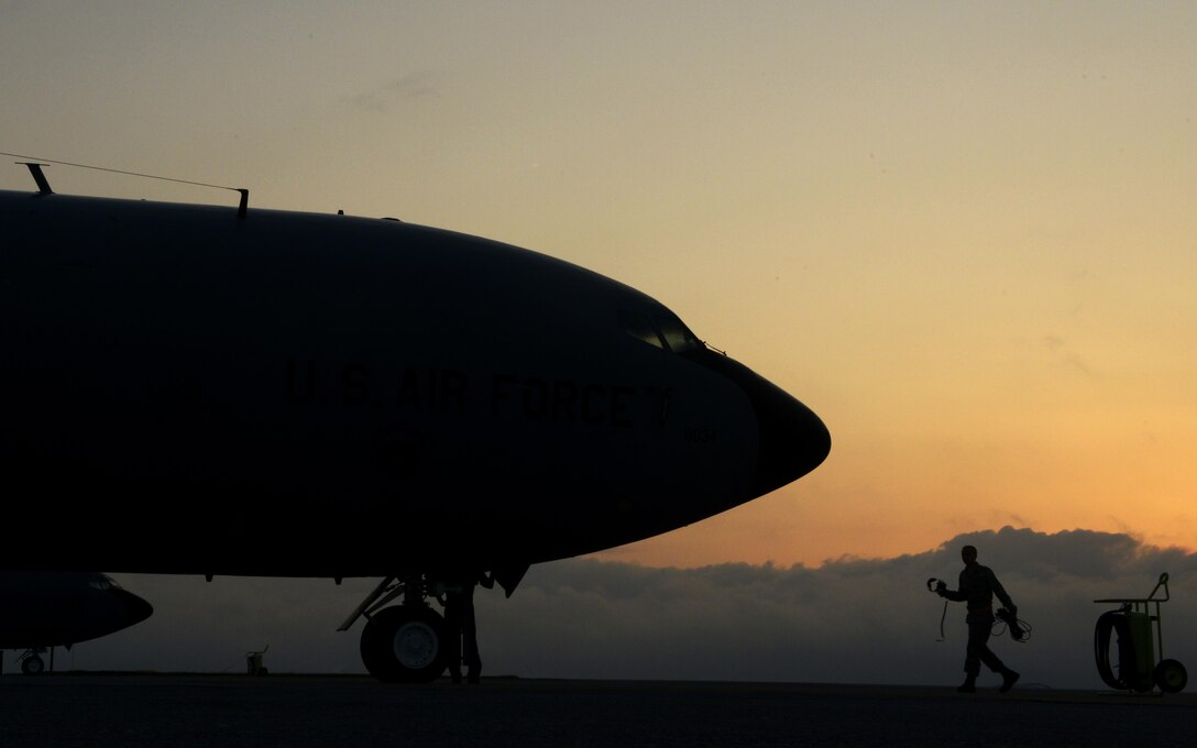 An Airman from the 909th Aircraft Maintenance Unit walks toward a KC-135 Stratotanker refueling aircraft during Exercise Forceful Tiger on Kadena Air Base, Japan, April 1, 2015. The Stratotankers allowed approximately 50 aircraft to stay airborne during the exercise for more than four hours.The KC-135 is assigned to the 909th Air Refueling Squadron. (U.S. Air Force photo/Staff Sgt. Maeson L. Elleman)
