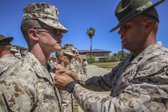 Lance Cpl. Clayton M. Howard, Platoon 1062, Delta Company, 1st Recruit Training Battalion, is promoted by his senior drill instructor Staff Sgt.  Sergio Ramirez at Marine Corps Base Camp Pendleton, March 26. Howard was meritoriously promoted to lance corporal prior to graduation and will represent the company as the honor graduate because all of his hard work and determination throughout recruit training. Howard is a native of San Antonio, and was recruited out of Recruiting Station San Antonio.
