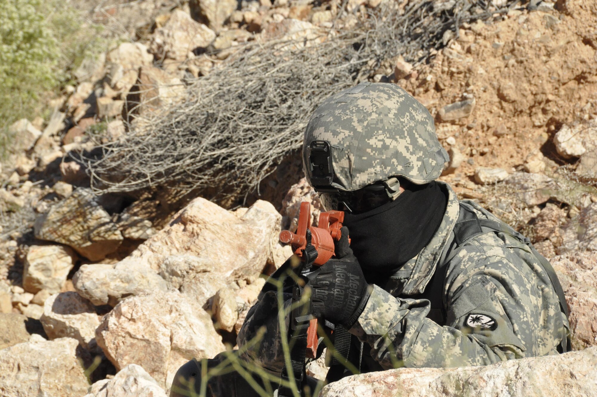Staff Sgt. Joseph Aquino, a medic assigned to the Guam Army National Guard, provides simulated security during a joint medical exercise at Nellis Air Force Base, Nev., March 27, 2015. The exercise showcased total force integration by including active duty, reserve, and guard units. (U.S. Air Force photo by Tech. Sgt. Colleen Urban)