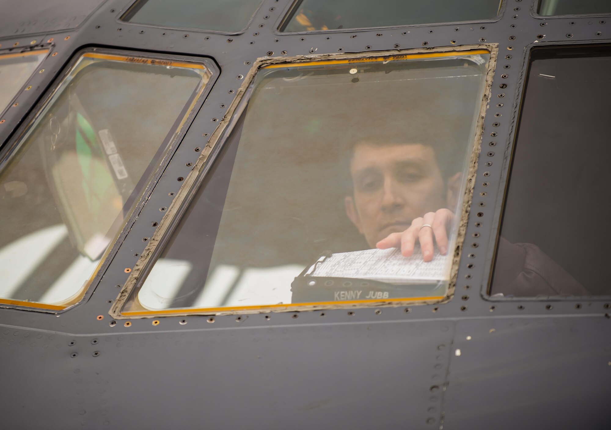 Capt. Kenneth Jubb, a 37th Airlift Squadron pilot, reaches for his clipboard to review flight plans during a training mission in a C-130J Super Hercules at Ramstein Air Base, Germany, Jan. 22, 2015. Since he was a child, Jubb has chased a dream to fly one day, and now as a pilot, he relives his childhood fantasy every time he takes to the air. (U.S. Air Force photo/Senior Airman Jonathan Stefanko)