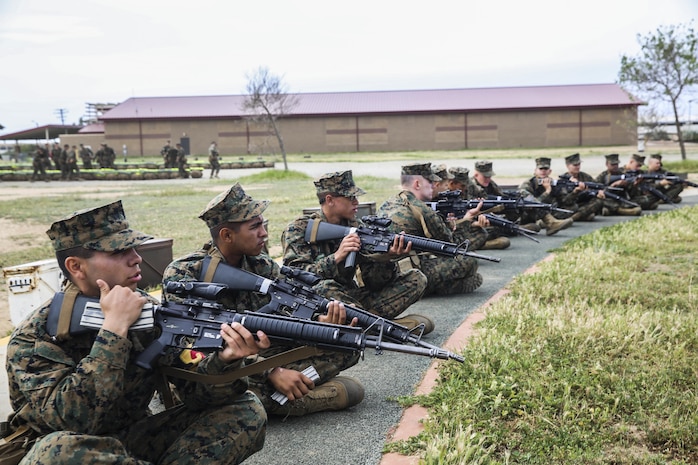 Recruits of Golf Company, 2nd Recruit Training Battalion, pause their snap in time for a brief period of instruction from their primary marksmanship instructor during Grass Week at Edson Range, Marine Corps Base Camp Pendleton, March 18.  Throughout Grass Week, PMIs teach recruits trigger control, sight picture, breathing control, sight alignment and natural point of aim. These basic fundamentals pave the way for recruits to become proficient and leave the range as marksmen, sharpshooters or experts