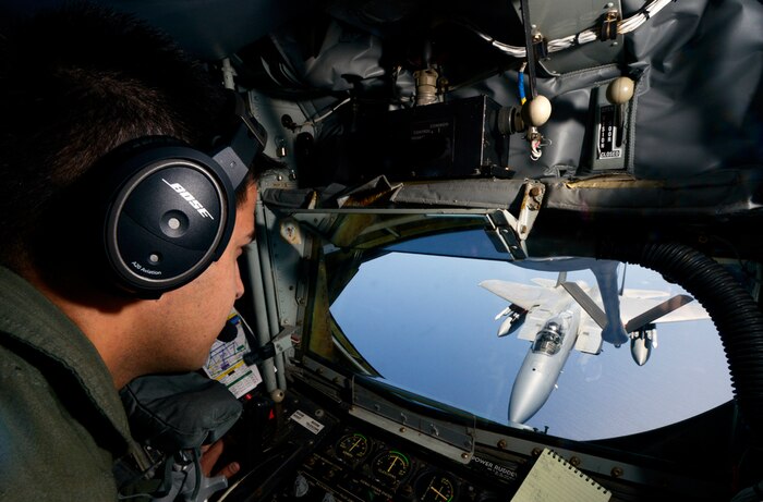 KADENA AIR BASE, Japan (Apr. 1, 2015) - U.S. Air Force Staff Sgt. Chance Italiano, 909th Air Refueling Squadron boom operator, moves the refueling boom from a KC-135 Stratotanker into position to refuel a U.S. Air Force F-15C Eagle during the Forceful Tiger exercise near Okinawa, Japan, April 1, 2015. During the aerial exercise, the Stratotankers delivered 800,000 pounds of fuel to approximately 50 aircraft. 