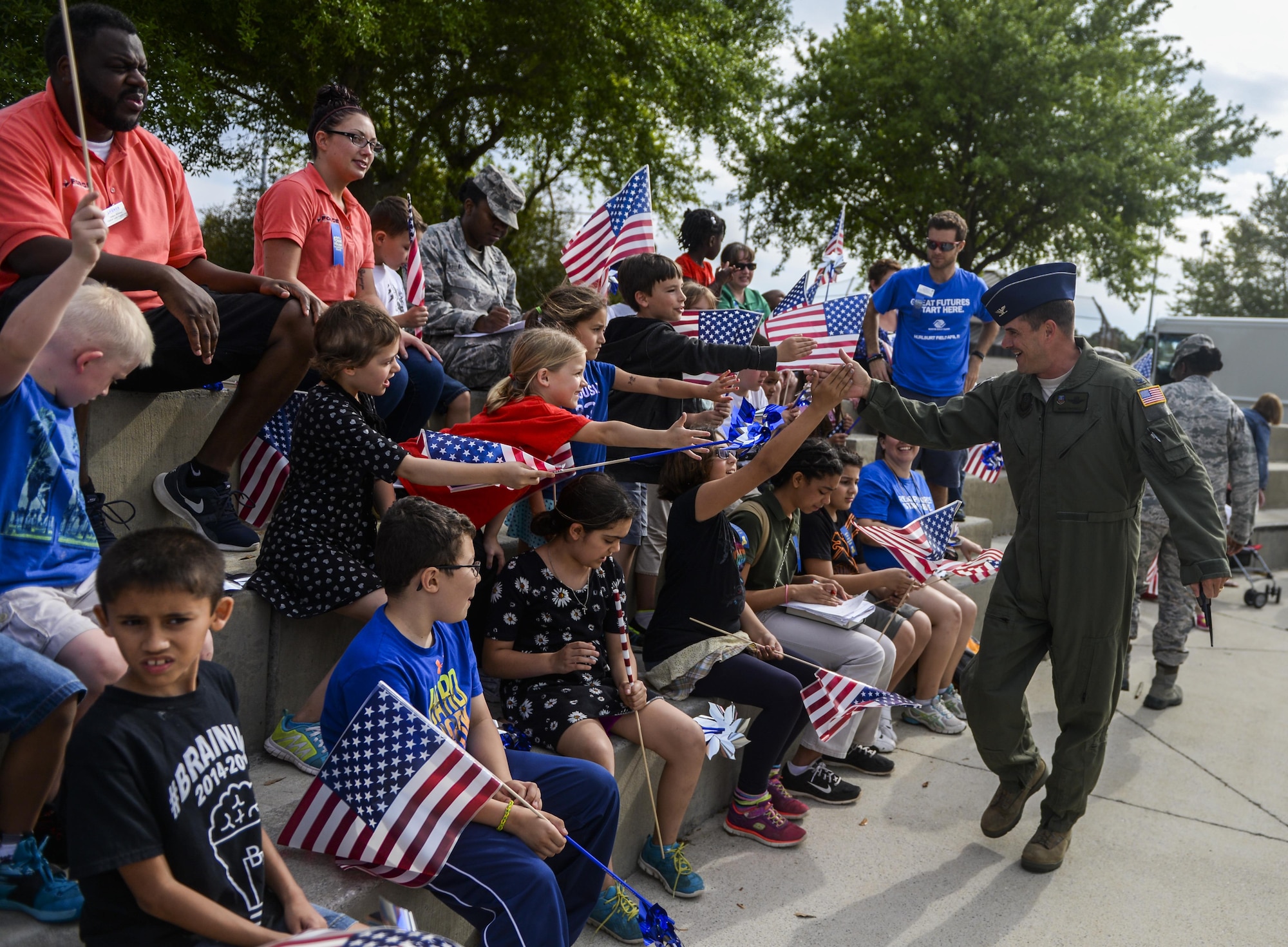 Col. Sean Farrell, 1st Special Operations Wing commander, gives high fives to children from the Youth Center after the Month of the Military Child and Child Abuse Prevention kickoff on Hurlburt Field, Fla., April 1, 2015. Hurlburt Field is home to more than 5,500 children who face unique challenges related to military life and culture. (U.S. Air Force photo/Senior Airman Christopher Callaway)