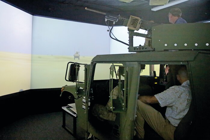Rep. Richard Nugent, a congressman with the 11th Congressional District of Florida, Marines and representatives from Marine Corps Base Hawaii sit in the combat convoy simulator March 31, 2015, aboard Marine Corps Base Hawaii. The simulator provides Marines with a life-like 360-degree training experience while preserving fuel and ammunition. (U.S. Marine Corps photo by Lance Cpl. Harley Thomas/Released)