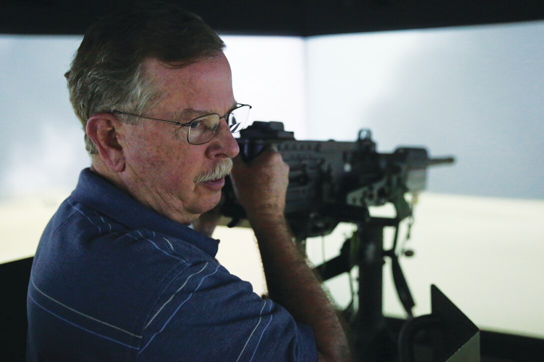 Rep. Richard Nugent, a congressman with the 11th Congressional District of Florida, serves as a gunner during a convoy simulation, March 31, 2015, in the Combat Convoy Simulator aboard Marine Corps Base Hawaii. The congressman’s visit brought visitors to the CCS, an immersive environment designed for convoy operations and tactical scenario training. (U.S. Marine Corps photo by Lance Cpl. Harley Thomas/Released)