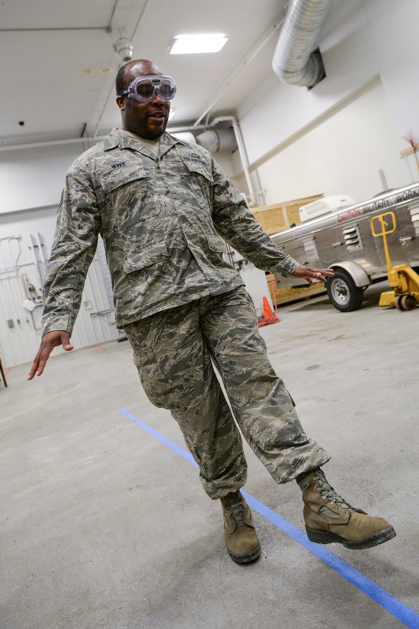U.S. Air Force Tech. Sgt. Ramel Wyke, a 354th Operations Support Squadron meteorologist, attempts to keep his balance during a simulated sobriety test during the 354th Fighter Wing “Amazing Race” as part of the Sexual Assault Awareness and Prevention month kickoff event at Eielson Air Force Base, Alaska, April 3, 2015. Beer goggles enabled Wyke to experience a simulated 0.07 percent blood alcohol level, which actively impaired his ability to maintain their balance and move in a straight line. (U.S. Air Force photo by Senior Airman Peter Reft/Released)