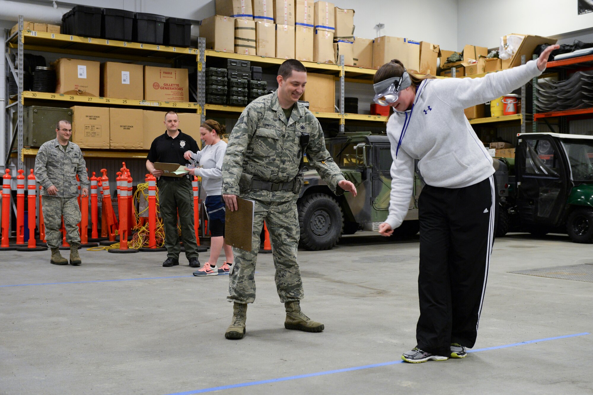 Icemen simulate sobriety tests during the 354th Fighter Wing “Amazing Race” as part of the Sexual Assault Awareness and Prevention month kickoff event at Eielson Air Force Base, Alaska, April 3, 2015. Race participants submitted to tests with the aid of beer goggles that simulated various levels of alcohol intoxication. (U.S. Air Force photo by Senior Airman Peter Reft/Released)