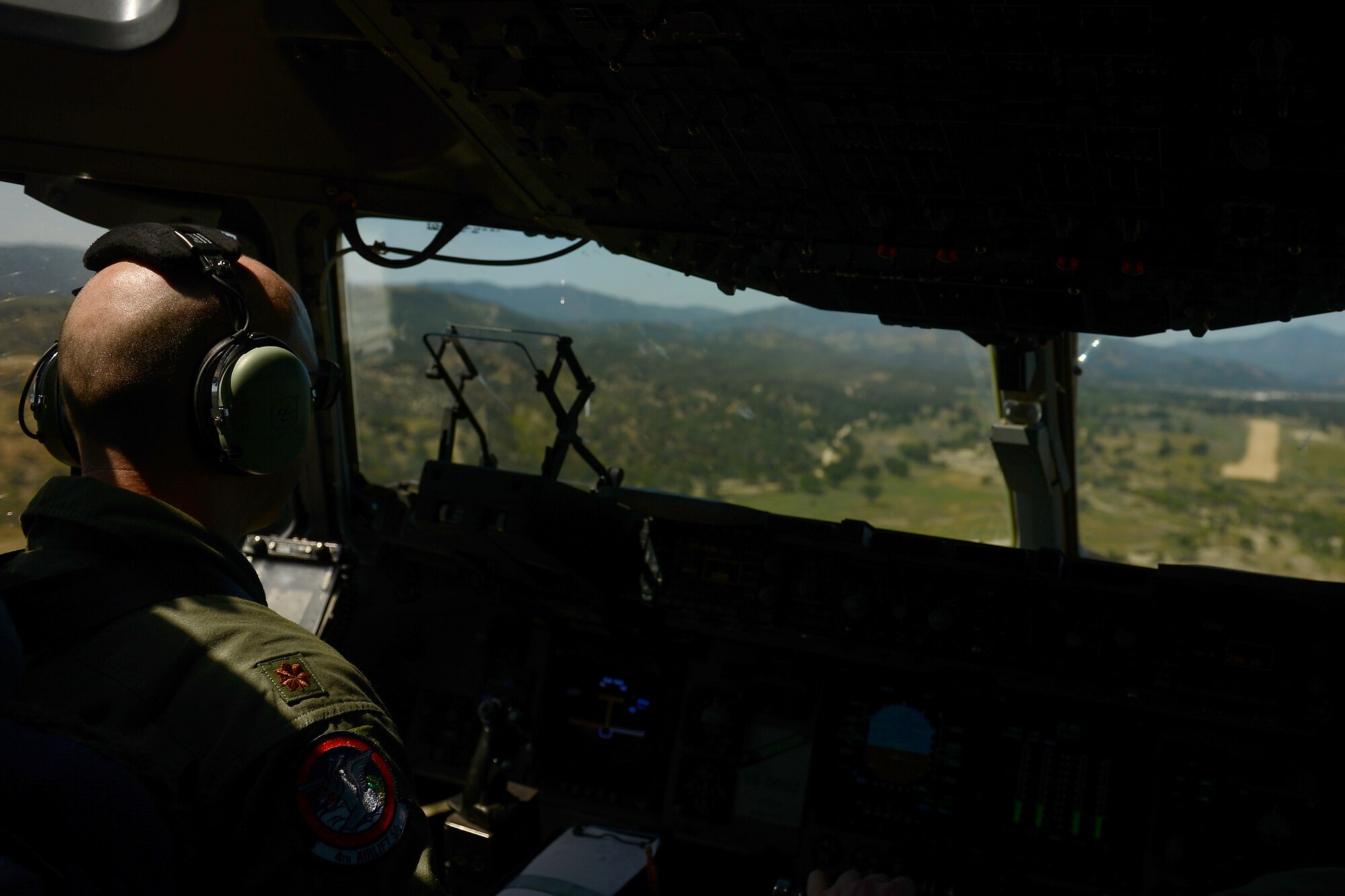 Maj. John McClelland, 4th Airlift Squadron, prepares to land a C1-17 Globemaster III April 2, 2015 at Fort Hunter Liggett, Calif. The C-17 crew conducted training on Semi Prepared Runway Operations at Fort Hunter Liggett and aerial refueling training over Western Washington. (U.S. Air Force photo/ Staff Sgt. Tim Chacon)