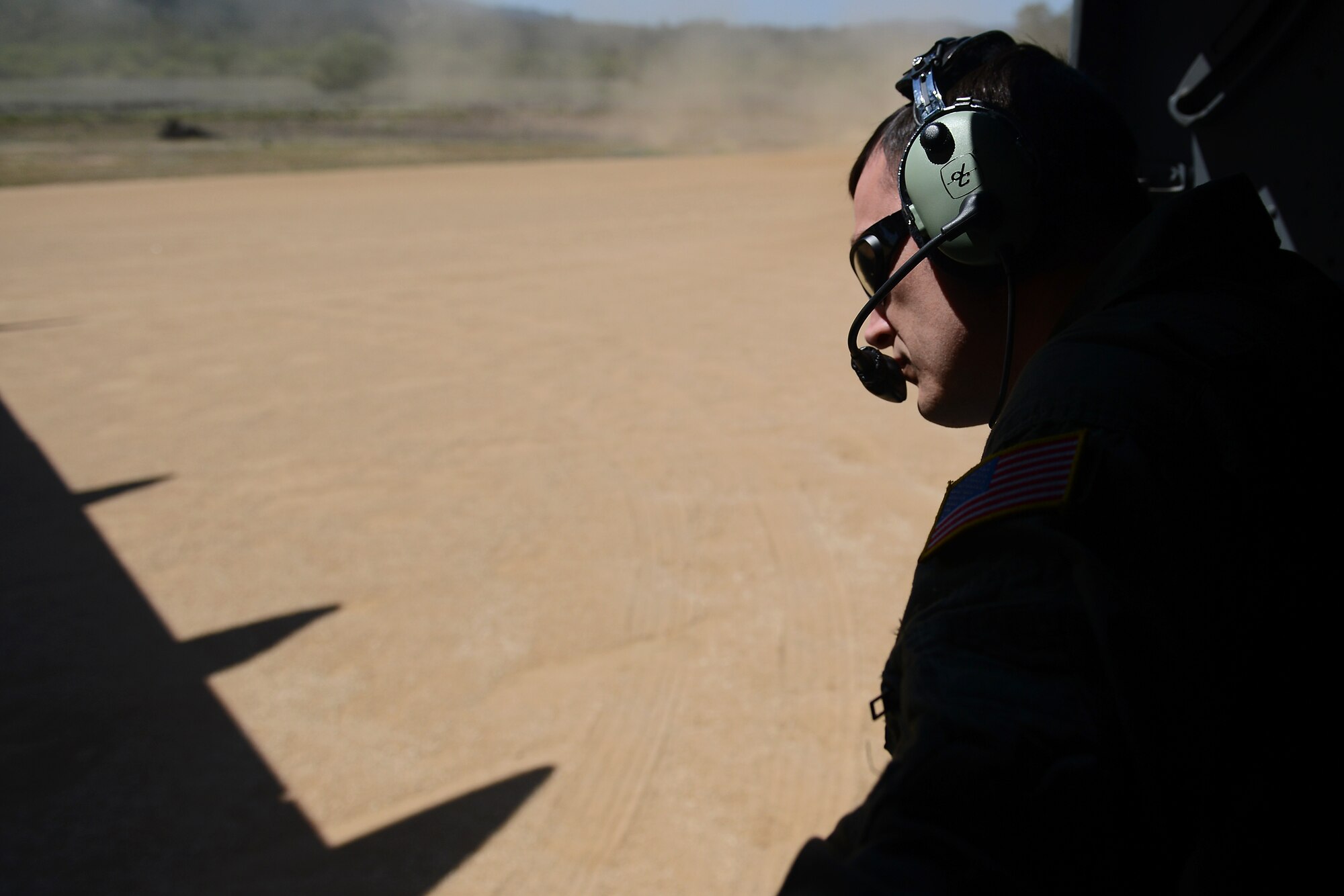 Staff Sgt. James Mabry, 4th Airlift Squadron loadmaster, prepares to guide a C-17 Globemaster III as it turns around April 2, 2015 at Joint Base-Lewis McChord, Wash. The C-17 crew conducted training on Semi Prepared Runway Operations at Fort Hunter-Liggett, Calif. (U.S. Air Force photo/ Staff Sgt. Tim Chacon)