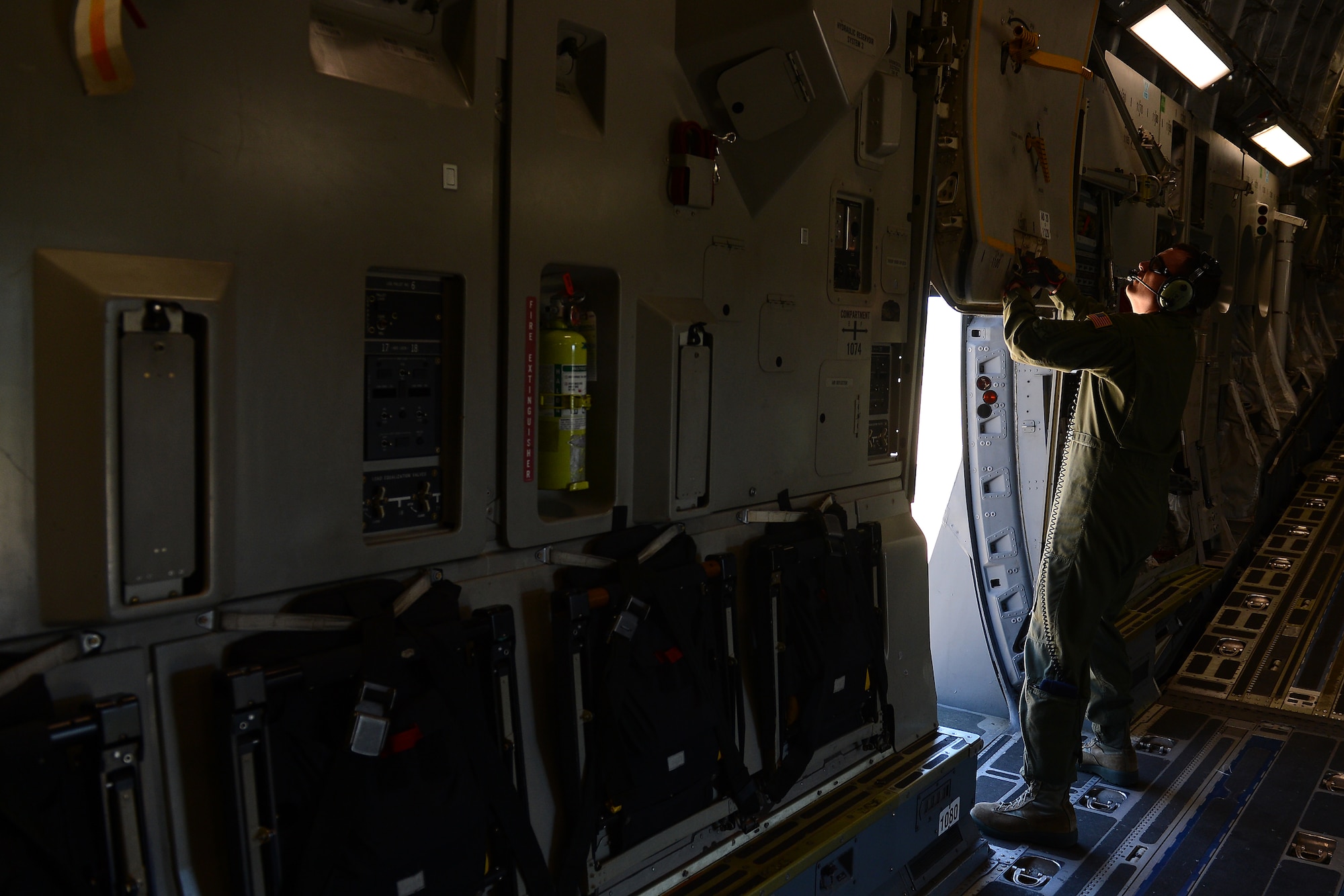 Staff Sgt. James Mabry, 4th Airlift Squadron loadmaster, guides a C-17 Globemaster III as it turns around April 2, 2015 at Joint Base-Lewis McChord, Wash. The C-17 crew conducted training on Semi Prepared Runway Operations at Fort Hunter-Liggett, Calif. (U.S. Air Force photo/ Staff Sgt. Tim Chacon)