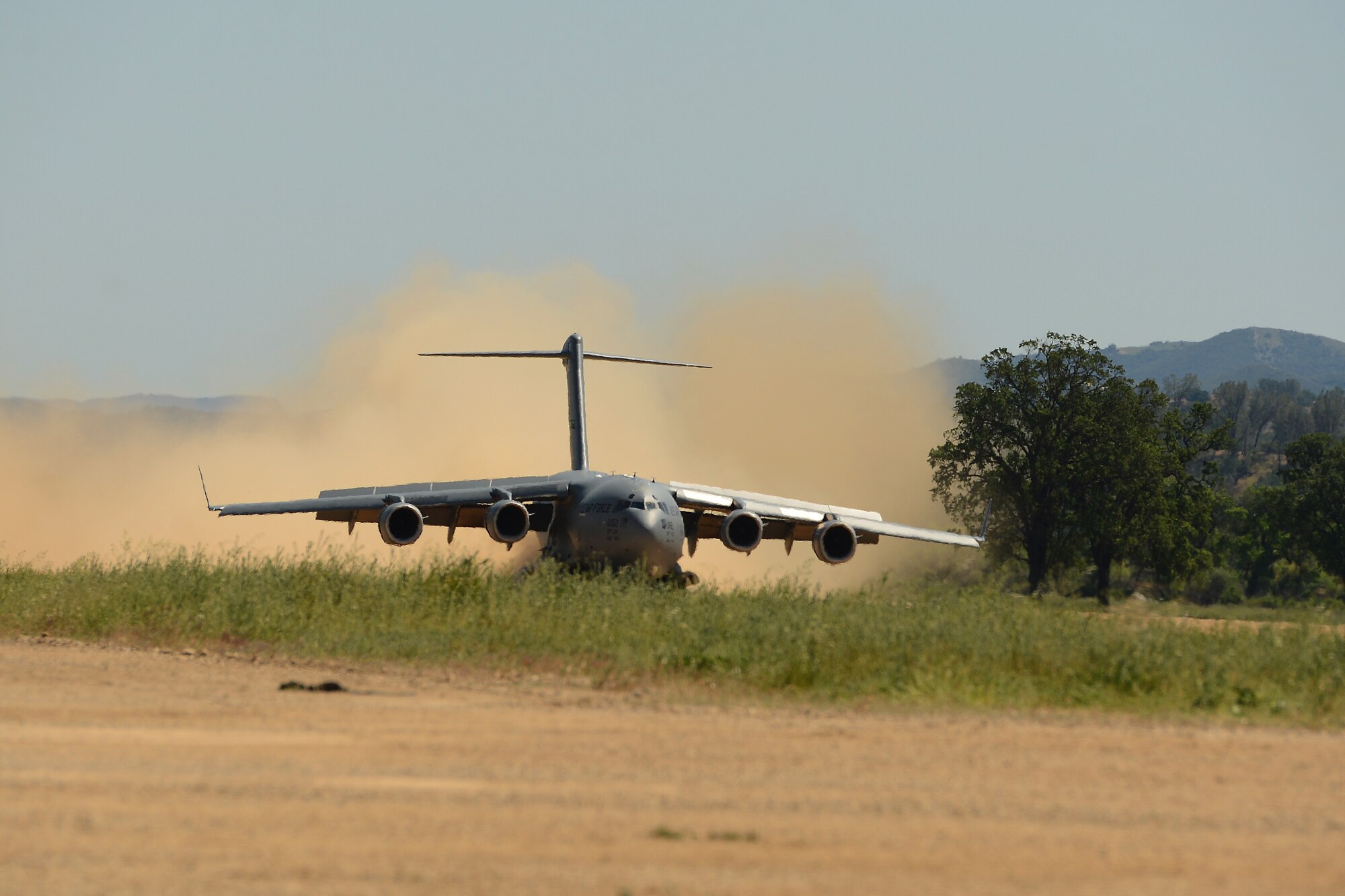 A C-17 Globemaster III from the 62nd Airlift Wing lands April 2, 2015 at Fort Hunter Liggett, Calif. The C-17 crew conducted training on Semi Prepared Runway Operations at Fort Hunter Liggett and aerial refueling training over Western Washington. (U.S. Air Force photo/ Staff Sgt. Tim Chacon)