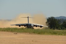 A C-17 Globemaster III from the 62nd Airlift Wing lands April 2, 2015 at Fort Hunter Liggett, Calif. The C-17 crew conducted training on Semi Prepared Runway Operations at Fort Hunter Liggett and aerial refueling training over Western Washington. (U.S. Air Force photo/ Staff Sgt. Tim Chacon)
