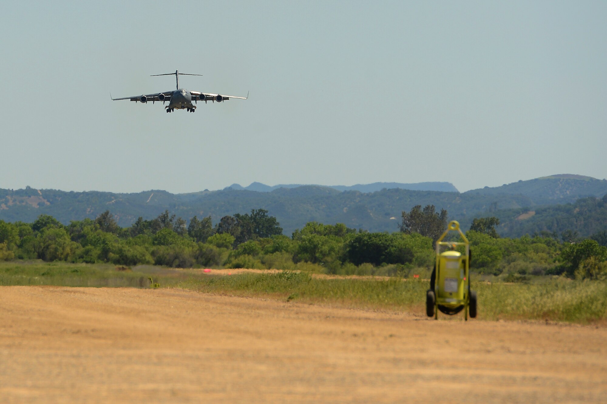 A C-17 Globemaster III from the 62nd Airlift Wing lines up for final approach April 2, 2015 at Fort Hunter Liggett, Calif. The C-17 crew conducted training on Semi Prepared Runway Operations at Fort Hunter Liggett and aerial refueling training over Western Washington. (U.S. Air Force photo/ Staff Sgt. Tim Chacon)