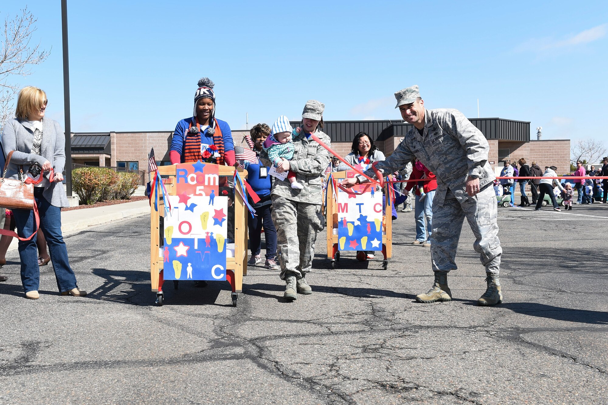 Children from the Crested Butte Child Development Center march in a parade in celebration of Month of the Military Child April 3, 2015, on Buckley Air Force Base, Colo. The parade occurred after Col. John Wagner, 460th Space Wing commander, signed the Month of the Military Child honorary proclamation. The proclamation officially cited April as Month of the Military Child. (U.S. Air Force photo by Airman 1st Class Samantha Saulsbury/Released)