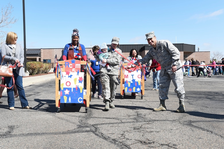 Children from the Crested Butte Child Development Center march in a parade in celebration of Month of the Military Child April 3, 2015, on Buckley Air Force Base, Colo. The parade occurred after Col. John Wagner, 460th Space Wing commander, signed the Month of the Military Child honorary proclamation. The proclamation officially cited April as Month of the Military Child. (U.S. Air Force photo by Airman 1st Class Samantha Saulsbury/Released)