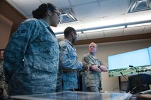 Airman 1st Class Jessica Guevara and Senior Airman Christopher Davis, 47th Operations Support Squadron air traffic controllers shows the Air Traffic Control Tower Simulator System to Chief Master Sgt. of the Air Force James Cody at Laughlin Air Force Base, Texas, April 2, 2015. The tower simulator is used as a tool for air traffic controllers undergoing training and uses voice recognition technology to interpret controller commands in a simulated environment. (U.S. Air Force photo by Staff Sgt. Nathan Maysonet)   