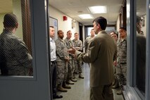 Ted Davis (center), Office of Special Investigations Detachment 305 special agent in charge, explains the purposes of different holding rooms during the OSI 201 Orientation briefing, Apr. 2, 2015, at Joint Base Lewis-McChord, Wash. The briefing, which was designed to be simple and to the point, covered a variety of topics such as Det. 305’s area of responsibility, the types of cases they have investigated in the last year, and what commanders and first sergeants can expect from OSI. (U.S. Air Force photo/Senior Airman Rebecca Blossom)