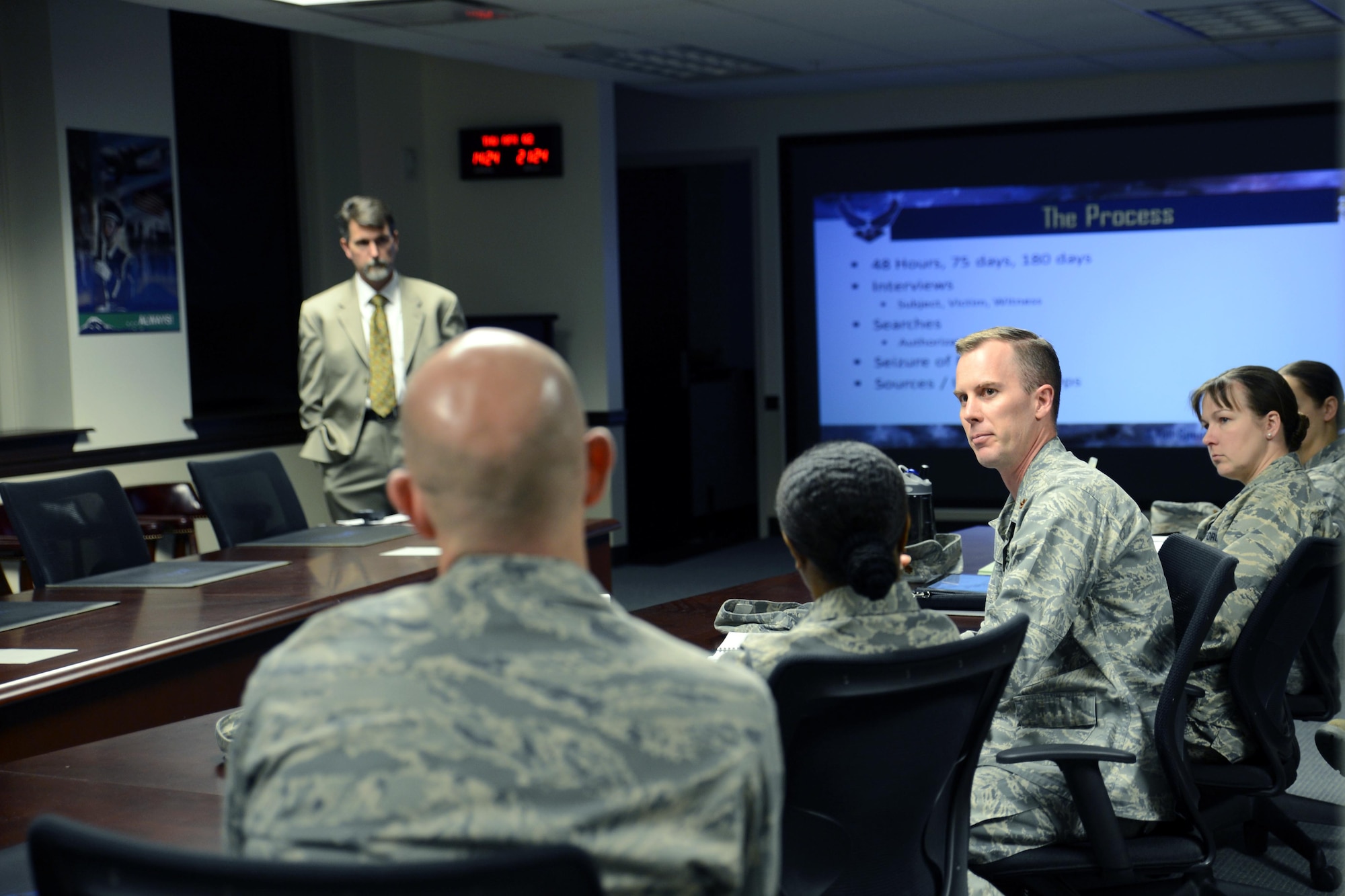 Maj. Clinton Varty (right), 62nd Maintenance Squadron commander, discusses his experience of previously working with the Office of Special Investigations during the OSI 201 Orientation briefing, Apr. 2, 2015, at Joint Base Lewis-McChord, Wash. Other leaders in the group asked questions about the use of audio and video recordings when interviewing Airmen, searches both on and off base, and the give and take that happens when informants come forward with information. (U.S. Air Force photo/Senior Airman Rebecca Blossom)
