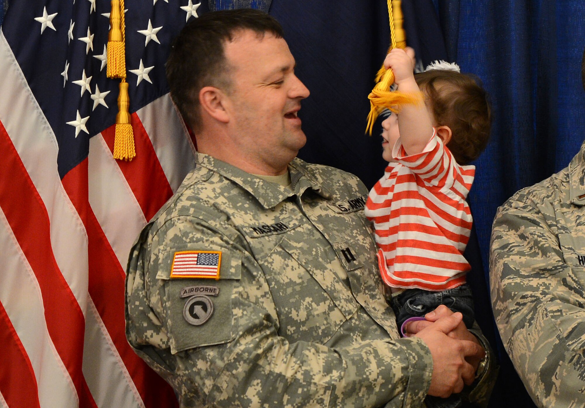 U.S. Army Capt. Michael Mascari, Headquarters Company 81st Regional Support Command, holds his daughter during the Month of the Military Child Proclamation reading at the Statehouse in Columbia S.C., April 2, 2015. Hudson and his son attended the Month of the Military Child Proclamation reading by South Carolina Governor Nikki Haley. (U.S. Air Force photo by Senior Airman Jensen Stidham/Released)