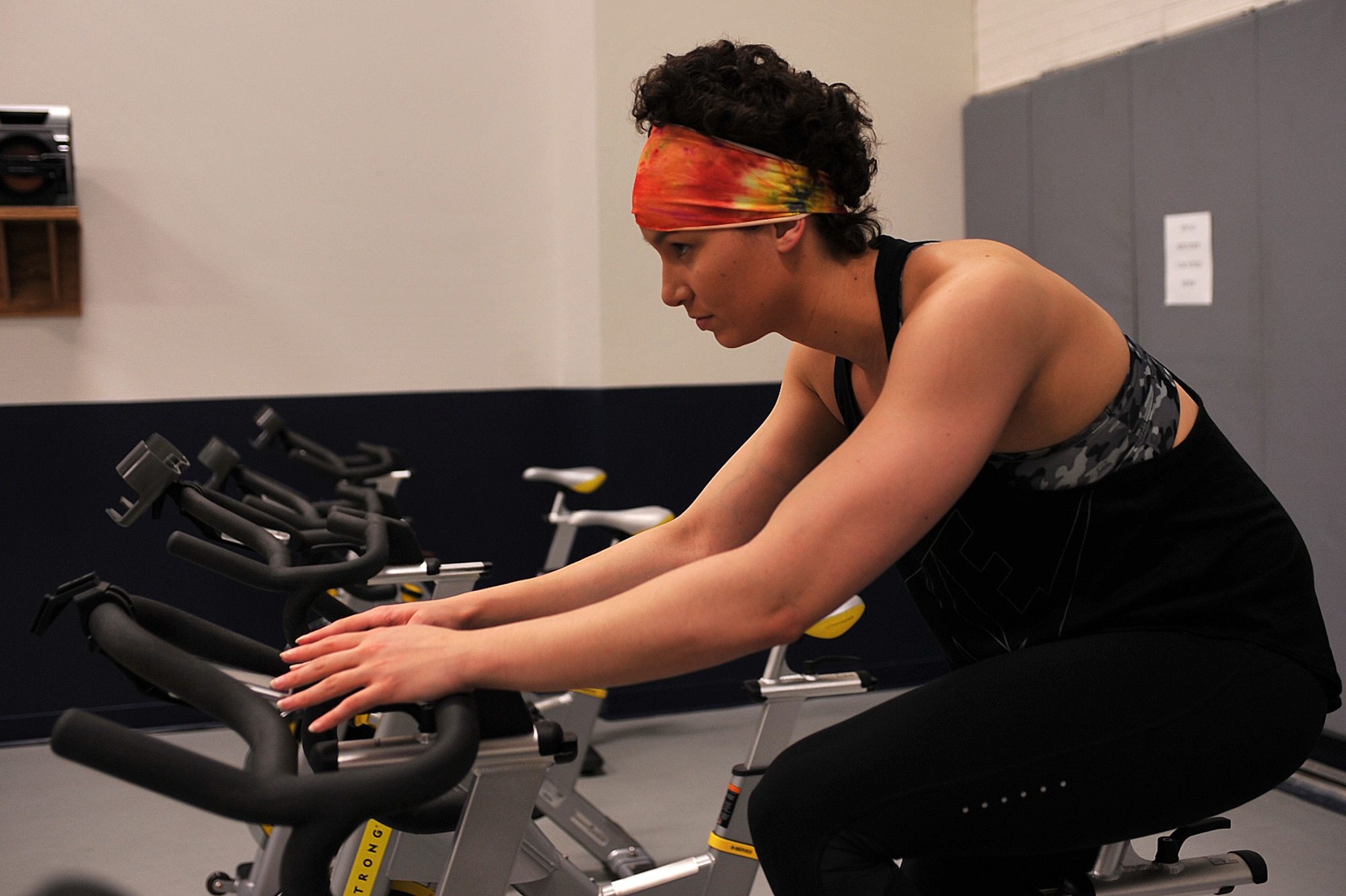 Senior Airman Myiah Castillejo, 348th Reconnaissance Squadron, maintains the health of her heart and lungs after radiation treatment by indoor cycling on Grand Forks Air Force Base, N.D., March 29, 2015. The radiation was used in conjunction with chemotherapy to treat the Hodgkin’s lymphoma that she was diagnosed with in January 2014. Castillejo was declared cancer free on Jan. 15, 2015. (U.S. Air Force photo/Airman 1st Class Bonnie Grantham/Released)