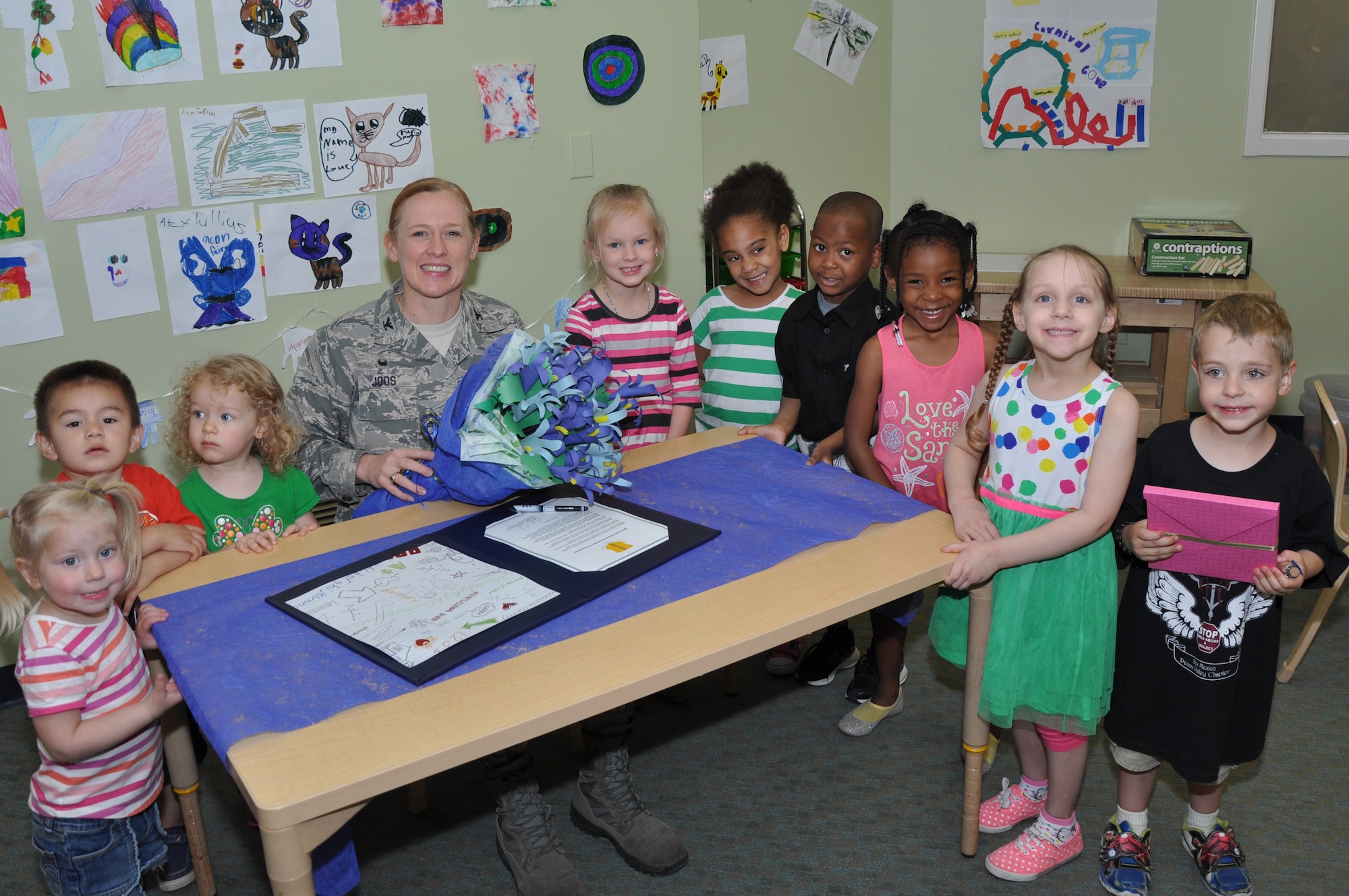 GOODFELLOW AIR FORCE BASE, Texas – Col. Kimberlee P. Joos, 17th Training Wing Commander, poses for a photo with Goodfellow youth at the Child Development Center April 2. While there, Joos signed a document proclaiming April Child Abuse Awareness Month. (U.S. Air Force photo/ Senior Airman Joshua Edwards)
