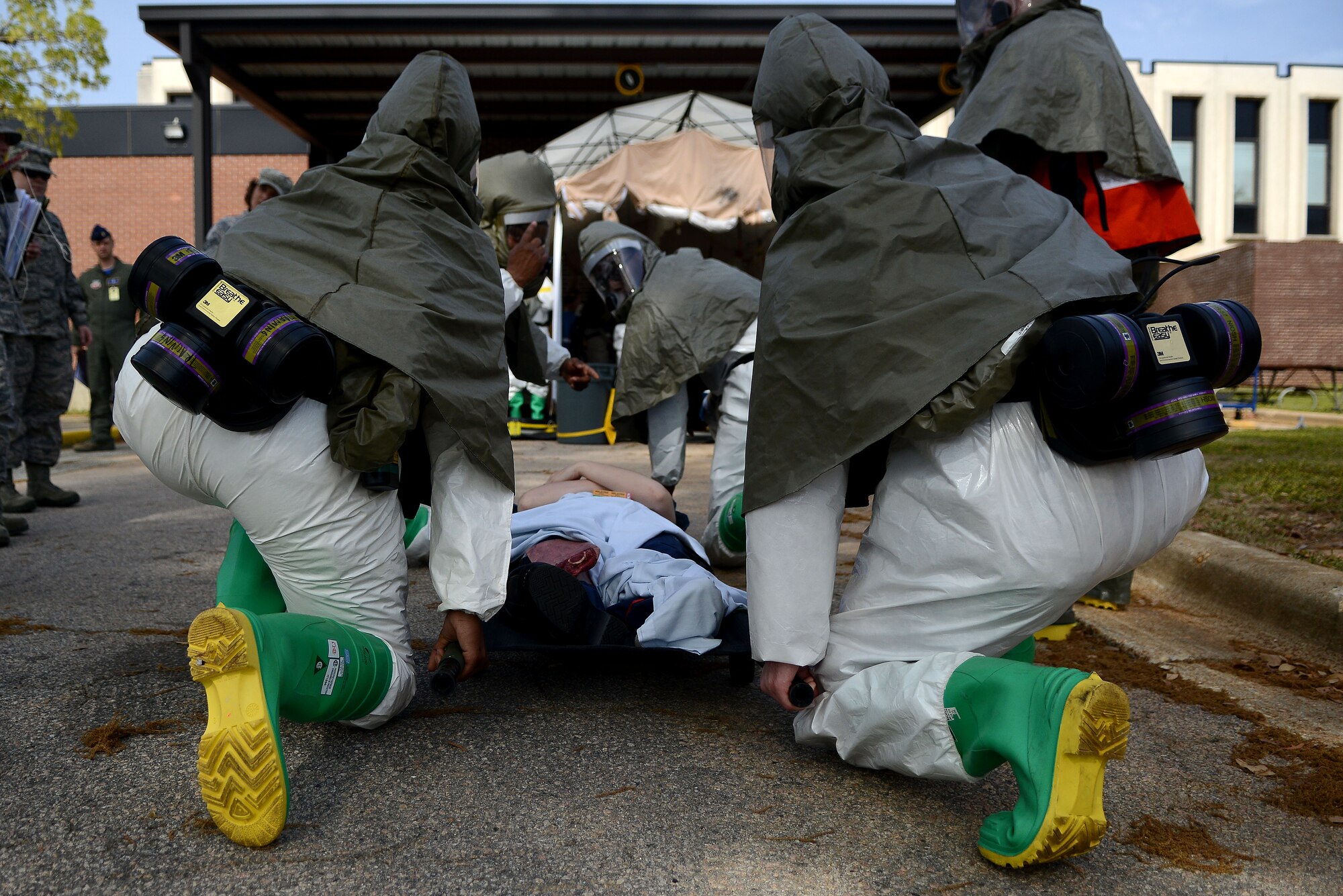 U.S. Air Force Airmen assigned to the 20th Medical Group prepare to lift a stretcher during a mass accident response exercise at Shaw Air Force Base, S.C., April 3, 2015. The exercise’s intent was to test Airmen’s ability to handle pressure under adverse situations and effectively triage patients. (U.S. Air Force photo by Airman 1st Class Michael Cossaboom/Released)