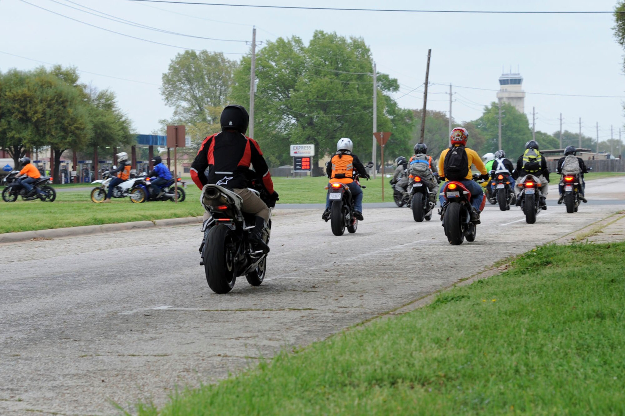 Motorcycle enthusiasts exit Chapel 2’s parking lot to participate in the 4th Annual Thunder on the Bayou motorcycle ride on Barksdale Air Force Base, La., April 4, 2014. The event was held to build morale and to also promote motorcycle safety. (U.S. Air Force photo/ Senior Airman Jannelle Dickey)
