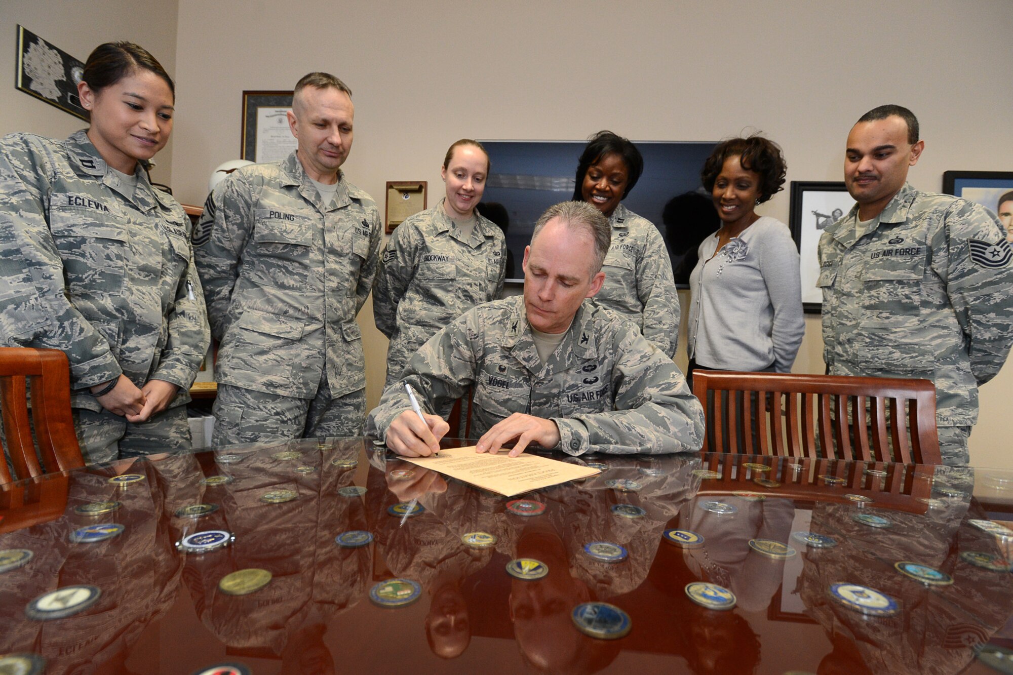 Col. Michael A. Vogel, 66th Air Base Group commander, signs a proclamation declaring April 12-19 as the Holocaust Days of Remembrance on base as (left to right) Capt. Kristina B. Eclevia, Command Chief Master Sgt. Craig A. Poling, Staff Sgt. Casey N. Brockway, Capt. Joy T. Lawal, Carrie K. Baker and Tech. Sgt. Raphael De La Rosa look on. The proclamation encourages everyone to “remember the terrible events of the Holocaust and always remain vigilant against acts of hatred, persecution and tyranny." (U.S. Air Force photo by Jerry Saslav)