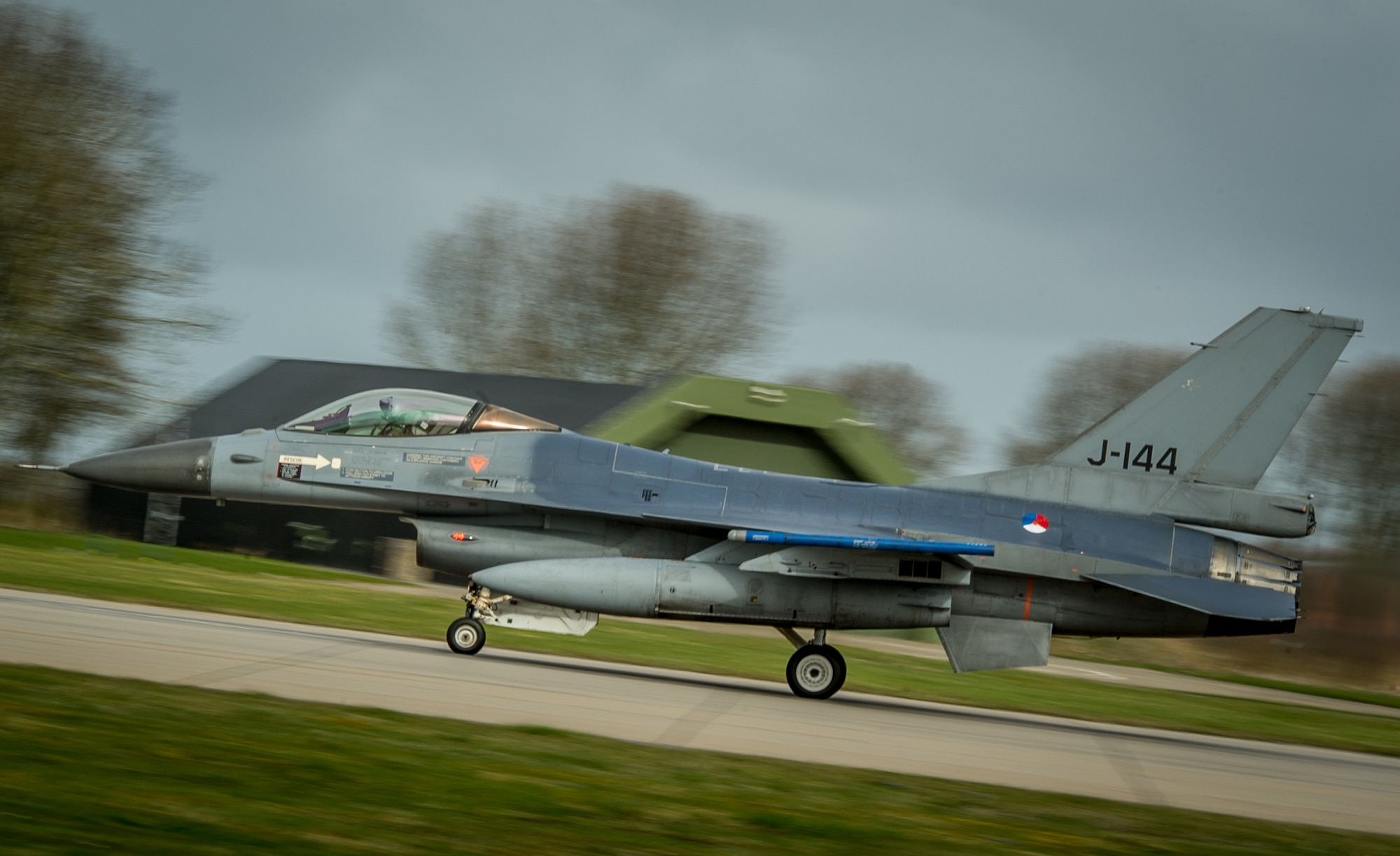 A Royal Netherlands Air Force F-16 Fighting Falcon turns on the afterburners as it takes off for a training flight with the 159th Expeditionary Fighter Squadron F-15C Eagles at Leeuwarden Air Base, Netherlands, April 3, 2015. The F-15s from the Florida and Oregon Air National Guard are deployed to Europe as the first ever ANG TSP here. These F-15s will conduct training alongside our NATO allies to strengthen interoperability and to demonstrate U.S. commitment to the security and stability of Europe. (U.S. Air Force photo/ Staff Sgt. Ryan Crane)