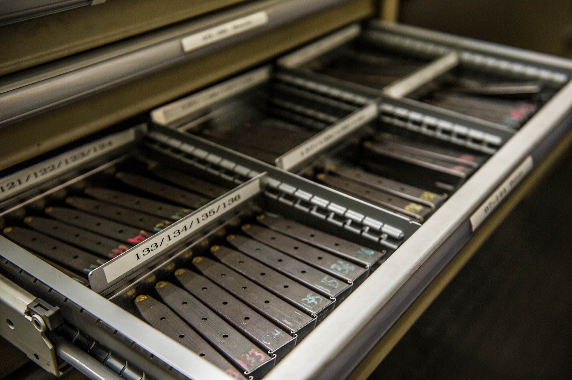 M-9 Beretta magazines are organized and stored upon receipt from an off duty patrolman at the 49th Security Forces Squadron armory at Holloman Air Force Base, N.M., April 2, 2015. SF armory personnel are responsible for arming SF members for their shift, ensuring their weapon systems are in proper working order and free of any defects or malfunctioning parts. The armory houses more than 900 weapon systems for on and off-duty SF members, Civil Engineer personnel, Office of Special Investigation agents and German Air Force members, they also hold the personally owned weapons of individuals that live on base. (U.S. Air Force photo by Airman 1st Class Aaron Montoya / Released)