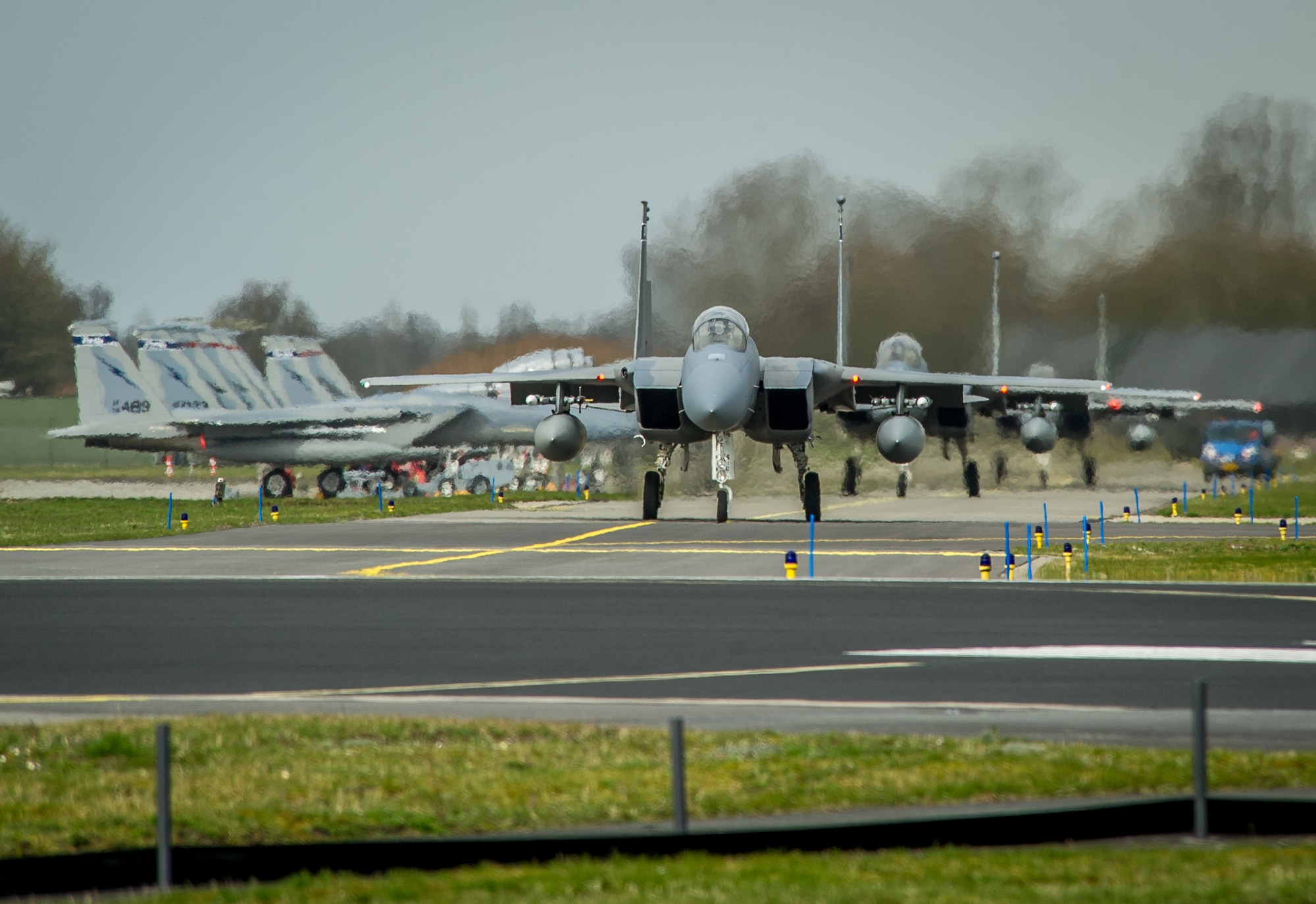 F-15C Eagles from the 159th Expeditionary Fighter Squadron taxi to take off for a training flight with the Royal Netherlands Air Force at Leeuwarden Air Base, Netherlands, April 3, 2015. The F-15s from the Florida and Oregon Air National Guard are deployed to Europe as the first ever ANG TSP here. These F-15s will conduct training alongside our NATO allies to strengthen interoperability and to demonstrate U.S. commitment to the security and stability of Europe. (U.S. Air Force photo/ Staff Sgt. Ryan Crane)