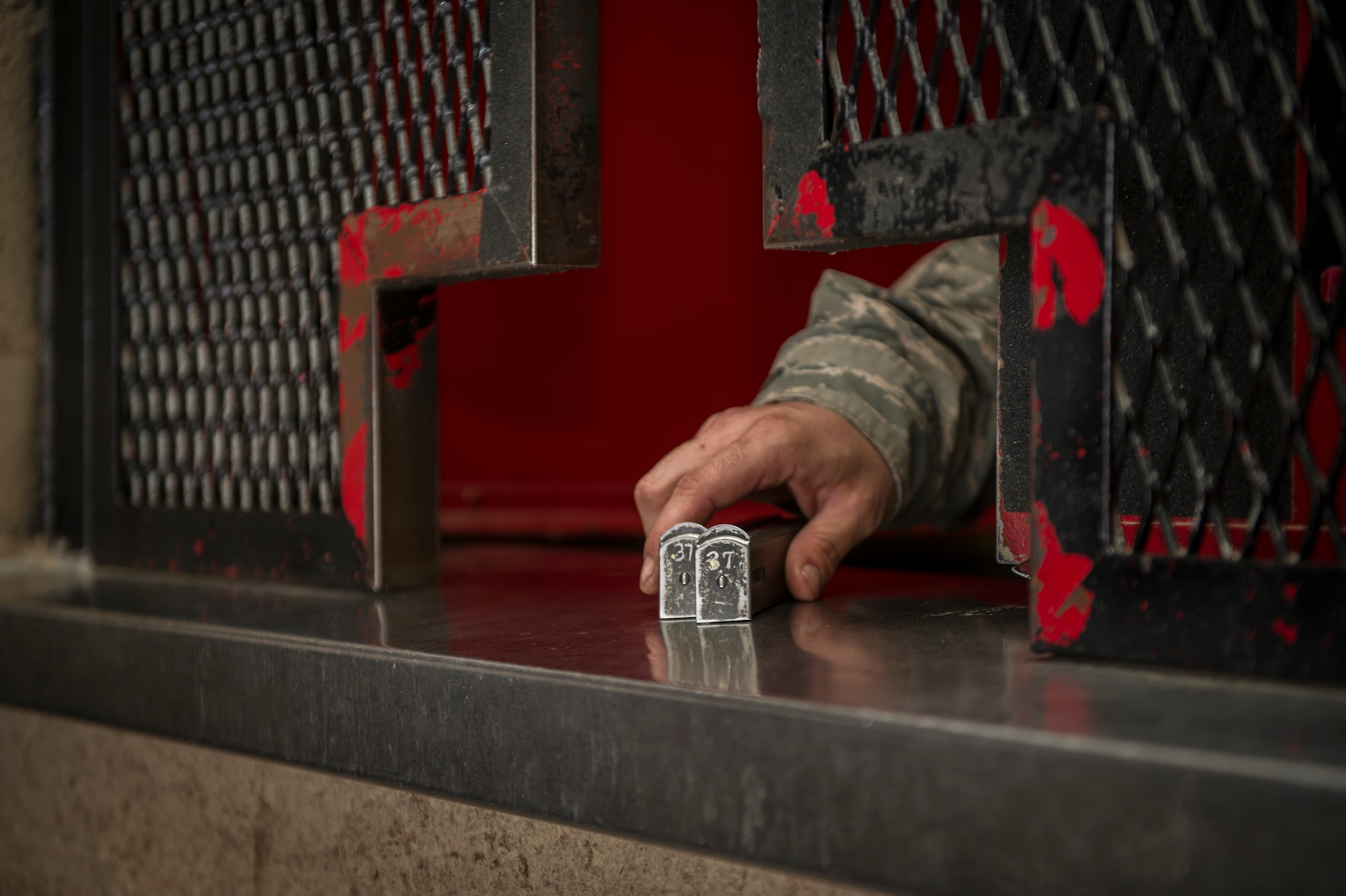 Senior Airman Tyrus Wilcox, 49th Security Forces Squadron daytime armorer, receives two M-9 Beretta magazines from a SF patrolman after returning from their shift at Holloman Air Force Base, N.M., April 2, 2015. The armory houses more than 900 weapon systems for on and off-duty SF members, Civil Engineer personnel, Office of Special Investigation agents and German Air Force members. They also hold the personally owned weapons of individuals that live on base. (U.S. Air Force photo by Airman 1st Class Aaron Montoya / Released)