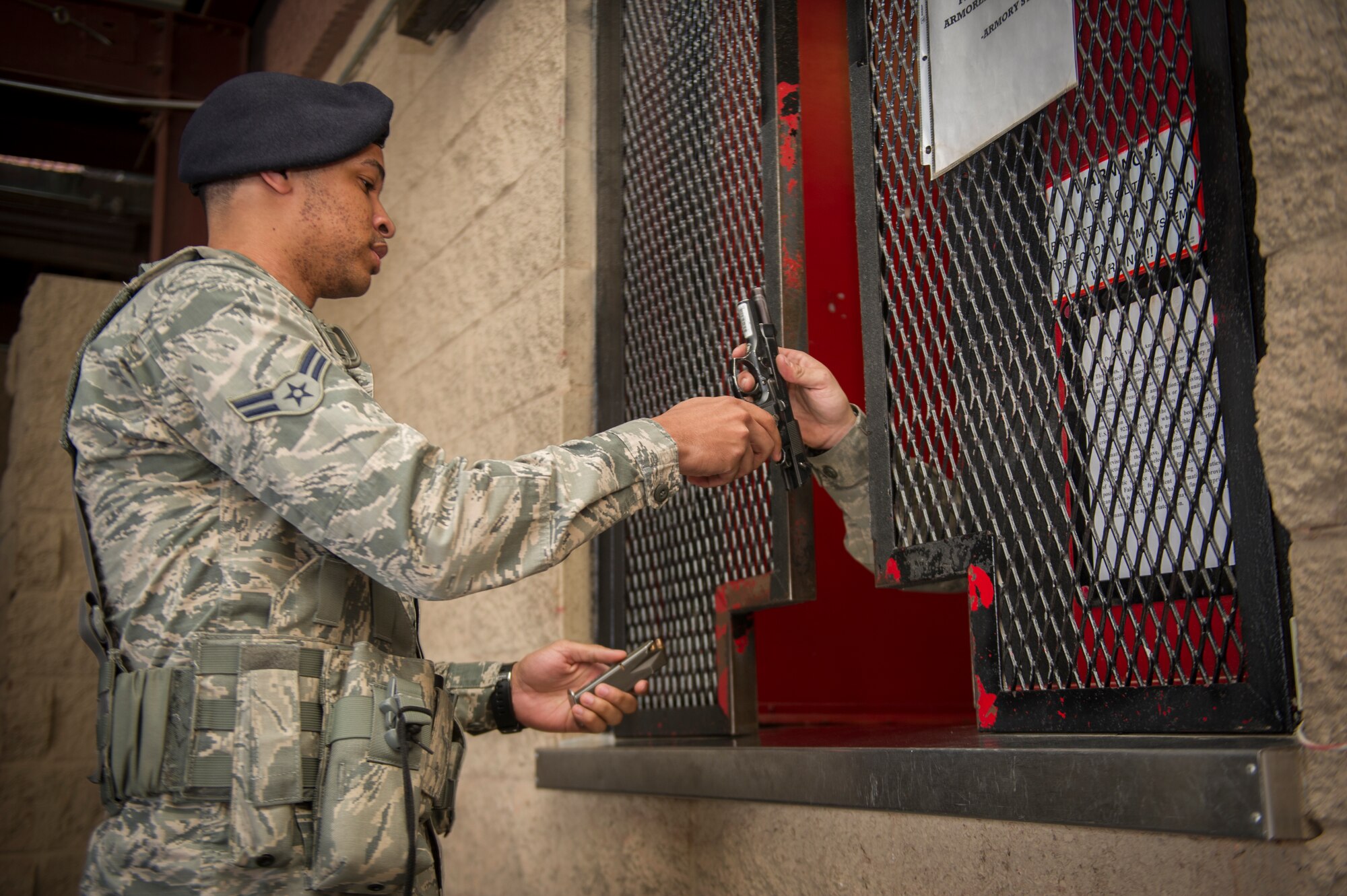 Airman 1st Class Joshua Wilson, 49th Security Forces Squadron patrolman, returns his daily issued M-9 Beretta at the end of his shift at Holloman Air Force Base, N.M., April 2, 2015. The SF armory is responsible for issuing and receiving weapon systems for SF posts and patrolmen. The weapons are cleared of ammunition and inspected for any flaws or discrepancies. If repairs are needed, they are channeled to the combat arms range for repairs. (U.S. Air Force photo by Airman 1st Class Aaron Montoya / Released)