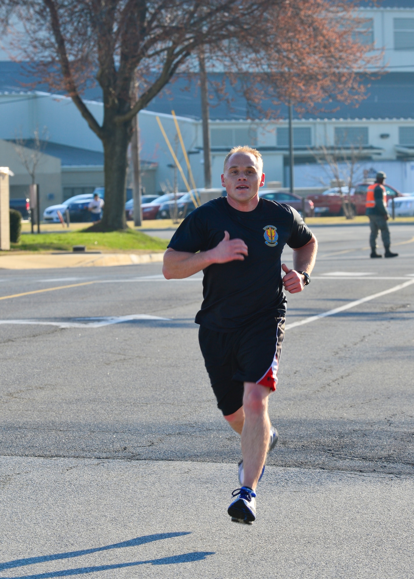 Tech. Sgt. Kellen Cone, 436th Aerial Port Squadron cargo processing NCO in charge, runs to the finish line during the Sexual Assault Prevention and Response 5 kilometer run/walk April 2, 2015, on Dover Air Force Base, Del. Cone was the first Airman to finish the race, running it in 14:55. (U.S. Air Force photo/Airman 1st Class William Johnson)