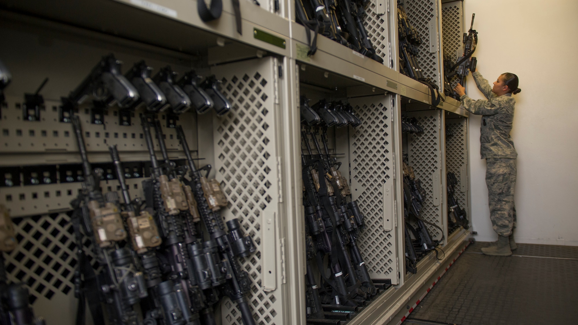 Senior Airman Alexandra Haytasingh, 49th Security Forces Squadron assistant non-commissioned officer in charge of the armory, returns an M-4 Carbine to the rack at Holloman Air Force Base, N.M., April 2, 2015. Armory personnel maintain and house weapon systems for both on and off-duty SF personnel, as well as store personally owned weapons and ammunition for residents living on base who have registered their weapon through SF. Currently the armory houses more than 90 personally owned weapons and their accompanying ammunition. (U.S. Air Force photo by Airman 1st Class Aaron Montoya / Released)