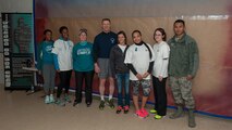 Col. Michael Grismer, 436th Airlift Wing commander, poses with Team Dover’s Sexual Assault Prevention and Response victim advocates in front of the Sexual Assault Awareness and Prevention Month Graffiti Wall April 2, 2015, at the fitness center on Dover Air Force Base, Del. Victim advocates are a support system for victims of sexual assault. (U.S. Air Force photo/Airman 1st Class Zachary Cacicia)