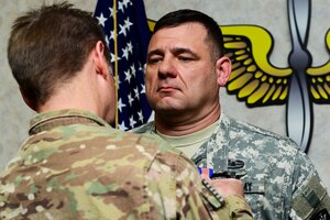 U.S. Army Col. Don Fallin, Special Mission Wing commander, left, presents a Soldier’s Medal to 1st Sgt. William Howard, Hotel Company, 1st Battalion, 222nd Aviation Regiment, 128th Aviation Brigade first sergeant, during a ceremony at Fort Eustis, Va., April 3, 2015. Fallin served as Howard’s unit commander while deployed to Kabul, Afghanistan, where Howard and three others saved the lives of five Afghan Soldiers, which earned Howard the decoration. (U.S. Air Force photo by Senior Airman Kimberly Nagle/Released)