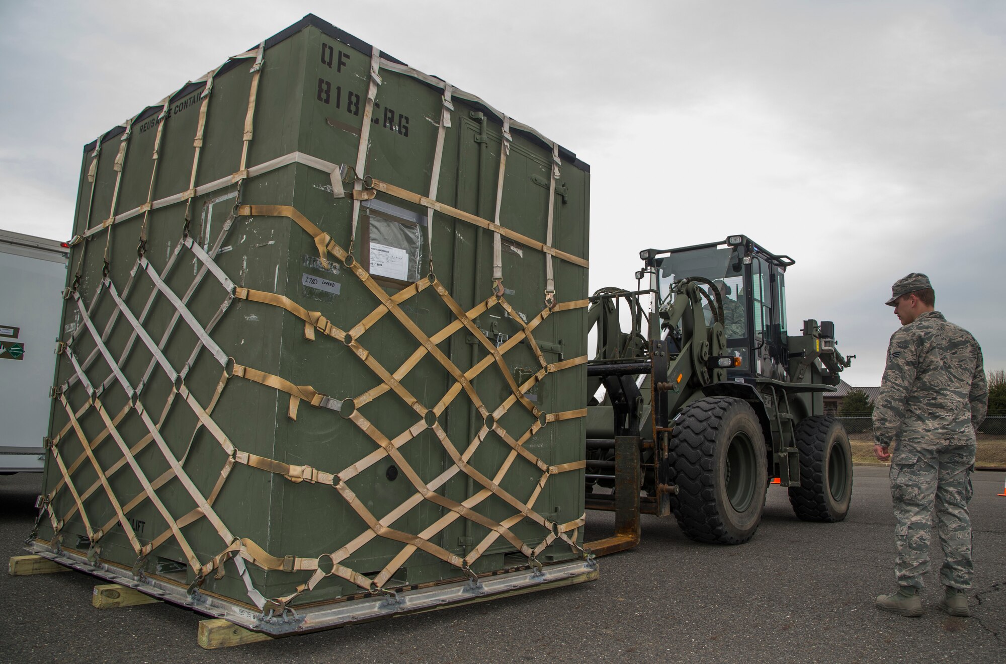 An Airmen lifts equipment with a forklift during the Devil Raid Mobility Exercise competition at Joint Base McGuire-Dix-Lakehurst, N.J., March 31, 2015. The specific equipment tasked, or unit type codes (UTCs), were processed to the point of unit assembly, complete with all required deployment documentation to conduct a joint inspection at the host base. Mobility folders for the individuals from tasked UTCs were also made available for review at ready line time. Personnel that were identified for tasked UTCs came from a previously established alert hard crew listing. (U.S. Air Force photo/Staff Sgt. Gustavo Gonzalez/RELEASED)