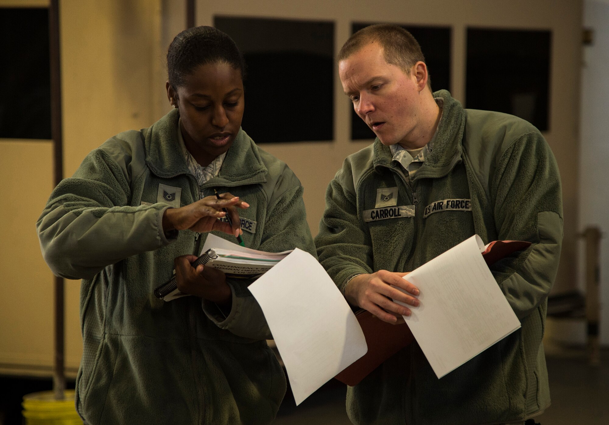Tech. Sgt. Aastria Gathings and Staff Sgt. Joshua Carroll, both assigned to the 818th Contingency Response Group, prepare for the Devil Raid Mobility Exercise competition at Joint Base McGuire-Dix-Lakehurst, N.J., March 31, 2015. The two phase exercise tested the ability of the units to process equipment and personnel for deployment upon the receipt of a tasking to order. (U.S. Air Force photo/Staff Sgt. Gustavo Gonzalez/RELEASED)