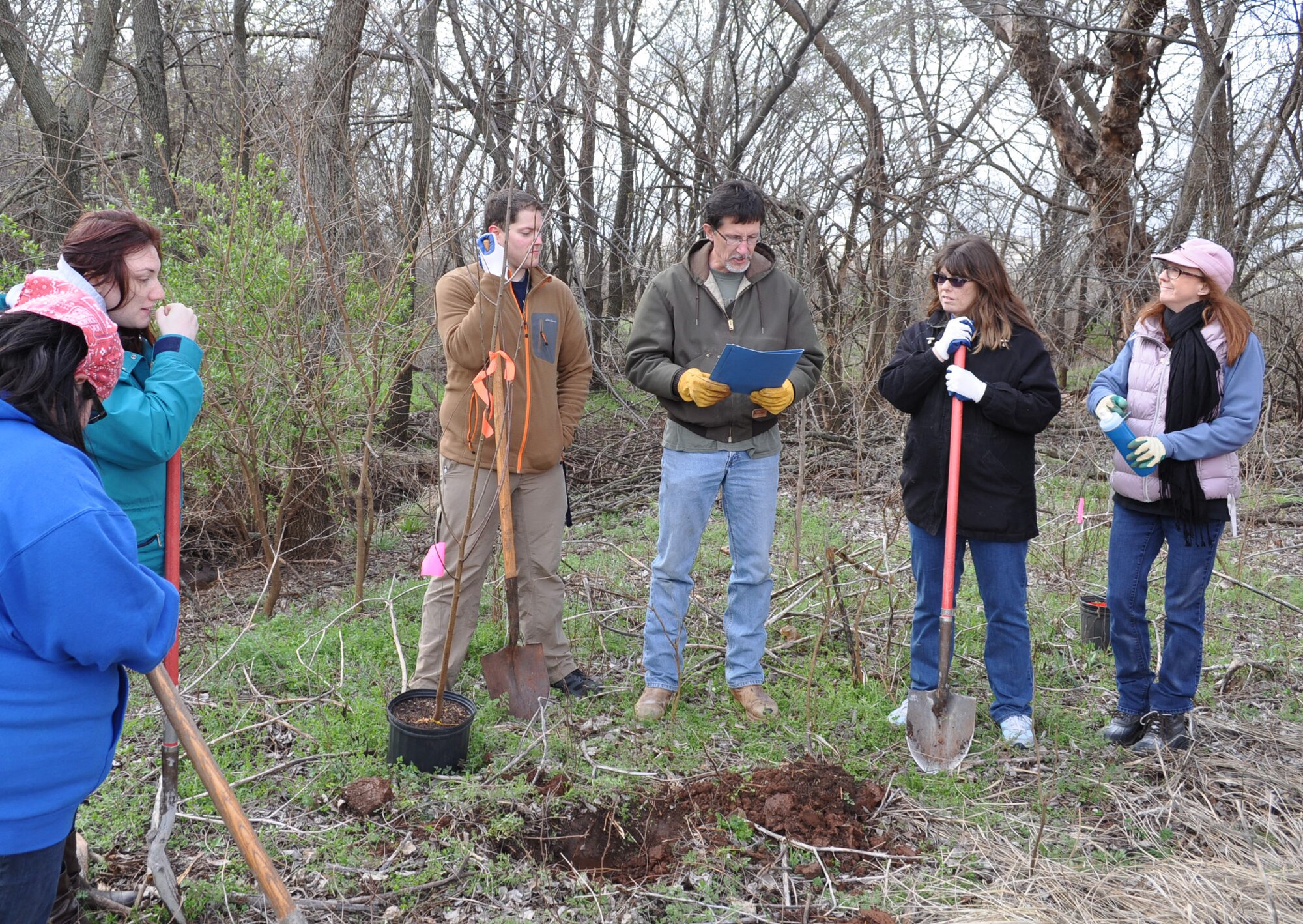 Air Force photo by April McDonald
John Krupovage, Tinker Natural Resources manager with the 72nd Air Base Wing Civil Engineering Directorate, center, reads a proclamation before planting the ceremonial tree, a Wild Cherry. The proclamation, signed by 72nd Air Base Wing and Tinker Installation Commander Col. Christopher Azzano, named March 27 Arbor Day at Tinker. To honor the occasion, Natural Resourses staff and volunteers from the Rose State College Tinker Federal Civic Leaders group planted 48 tress in the Urban Greenway.
