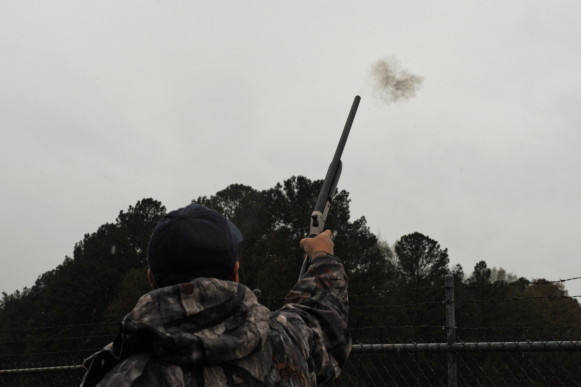 Dennis Lewis, U.S. Department of Agriculture Animal and Plant Health Inspection Service wildlife specialist, fires a pyrotechnic charge from a shotgun March 30, 2015, at Seymour Johnson Air Force Base, North Carolina. USDA APHIS members work around the clock to reduce the likelihood of bird strikes in conjunction with the base’s Bird Aircraft Strike Hazard program. (U.S. Air Force photo/Airman 1st Class Aaron J. Jenne)