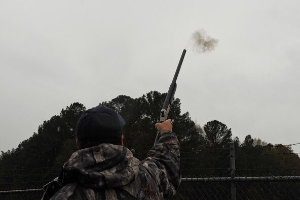 Dennis Lewis, U.S. Department of Agriculture Animal and Plant Health Inspection Service wildlife specialist, fires a pyrotechnic charge from a shotgun March 30, 2015, at Seymour Johnson Air Force Base, North Carolina. USDA APHIS members work around the clock to reduce the likelihood of bird strikes in conjunction with the base’s Bird Aircraft Strike Hazard program. (U.S. Air Force photo/Airman 1st Class Aaron J. Jenne)