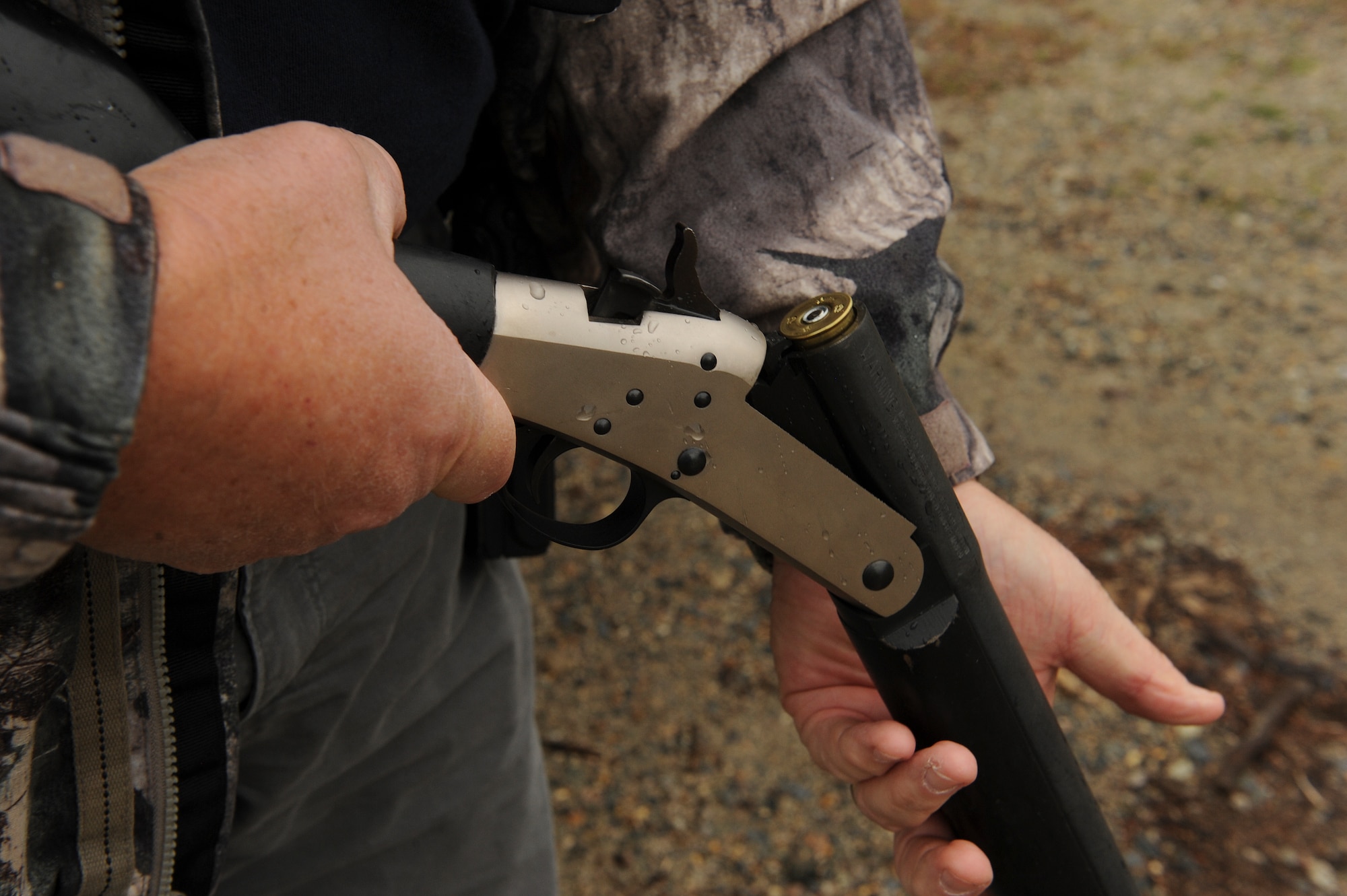 Dennis Lewis, U.S. Department of Agriculture Animal and Plant Health Inspection Service wildlife specialist, loads a shotgun with a pyrotechnic charge March 30, 2015, at Seymour Johnson Air Force Base, North Carolina. Local USDA APHIS members use pyrotechnic rounds, as well as other scare tactics, to keep birds out of the airspace prior to flight operations. (U.S. Air Force photo/Airman 1st Class Aaron J. Jenne)