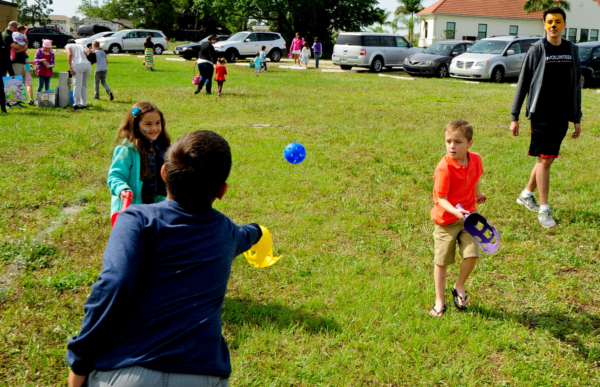 Children play scoop ball following the Annual Easter Egg Hunt March 28, 2015 at MacDill Air force Base, Fla. Scoop ball was among various activities offered to children following the egg hunt.  (U.S. Air Force photo by Senior Airman Jenay Randolph/Released)