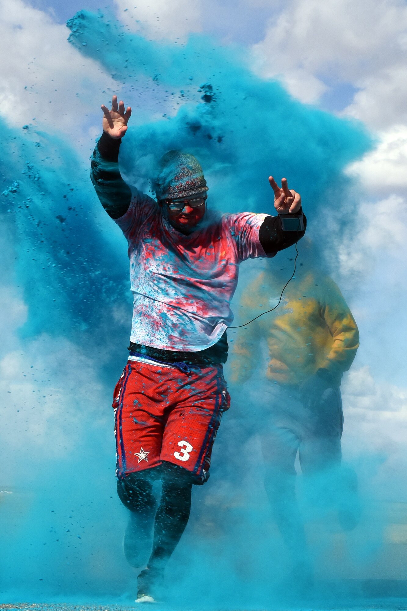 A Team Malmstrom member runs past the blue station of the Wingman Month kickoff color run April 1, 2015 at Malmstrom Air Force Base, Mont. The blue station, one of four set up around the 1.7 mile course, represented Child Abuse Prevention Month. (U.S. Air Force photo/Chris Willis)