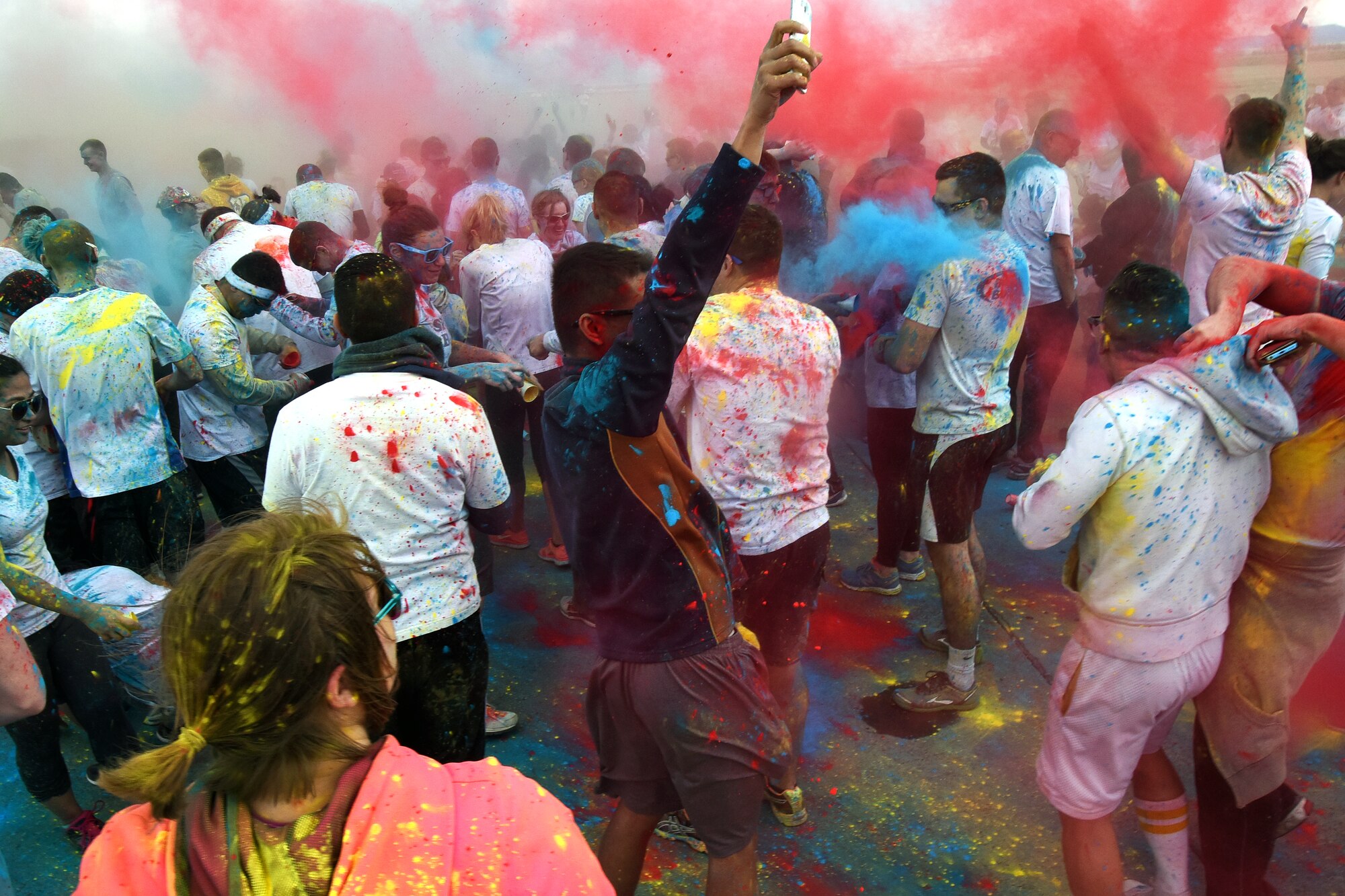 Team Malmstrom members take part in a color battle using powdered paint during the kickoff of Wingman Month April 1, 2015 at Malmstrom Air Force Base, Mont. The run aimed to faciliate a fun and creative take on a wing run, with Airmen, their families and civilians taking part in the feastvities. (U.S. Air Force photo/Chris Willis)
